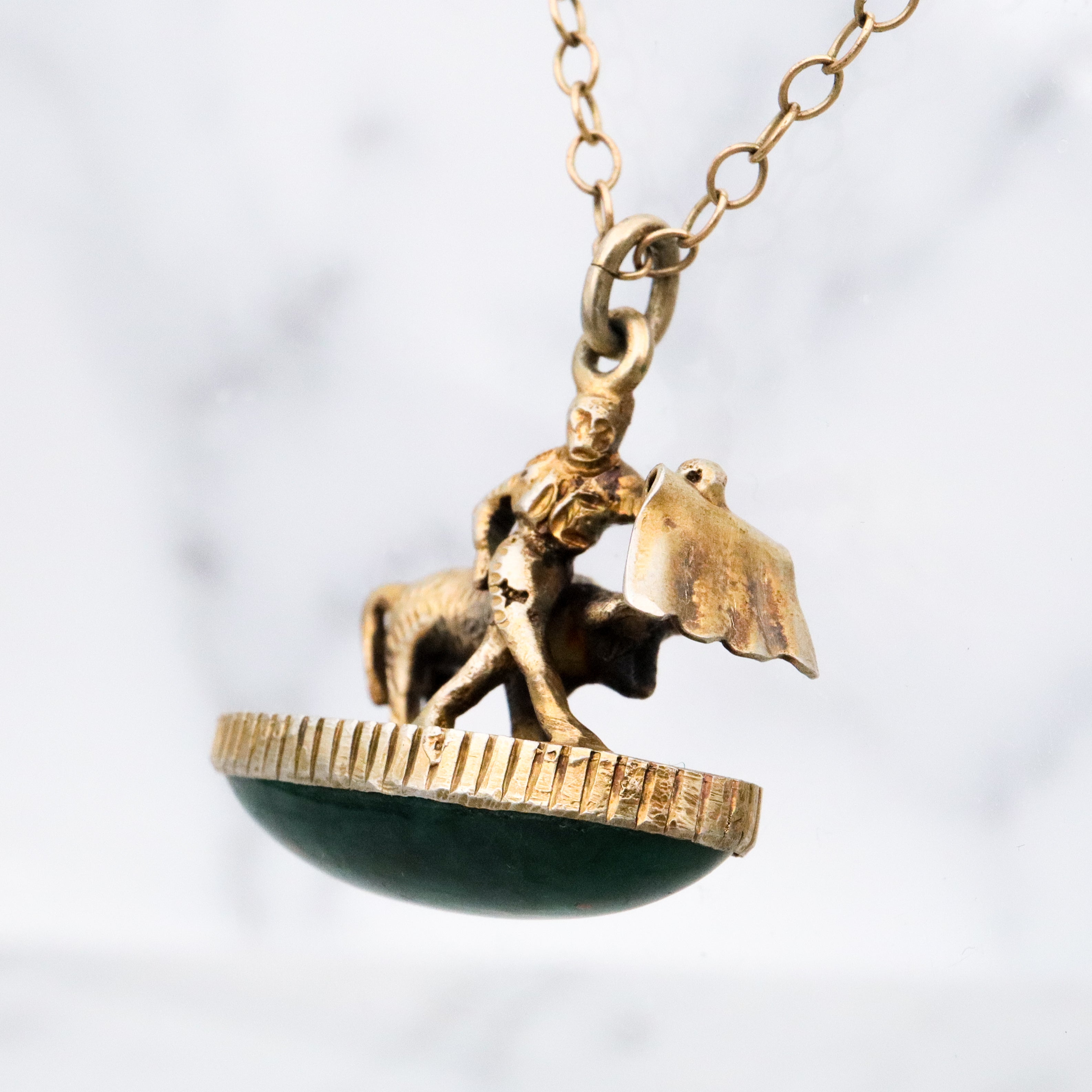 Antique gilt sterling figural matador & bull fob pendant w/faux bloodstone bottom