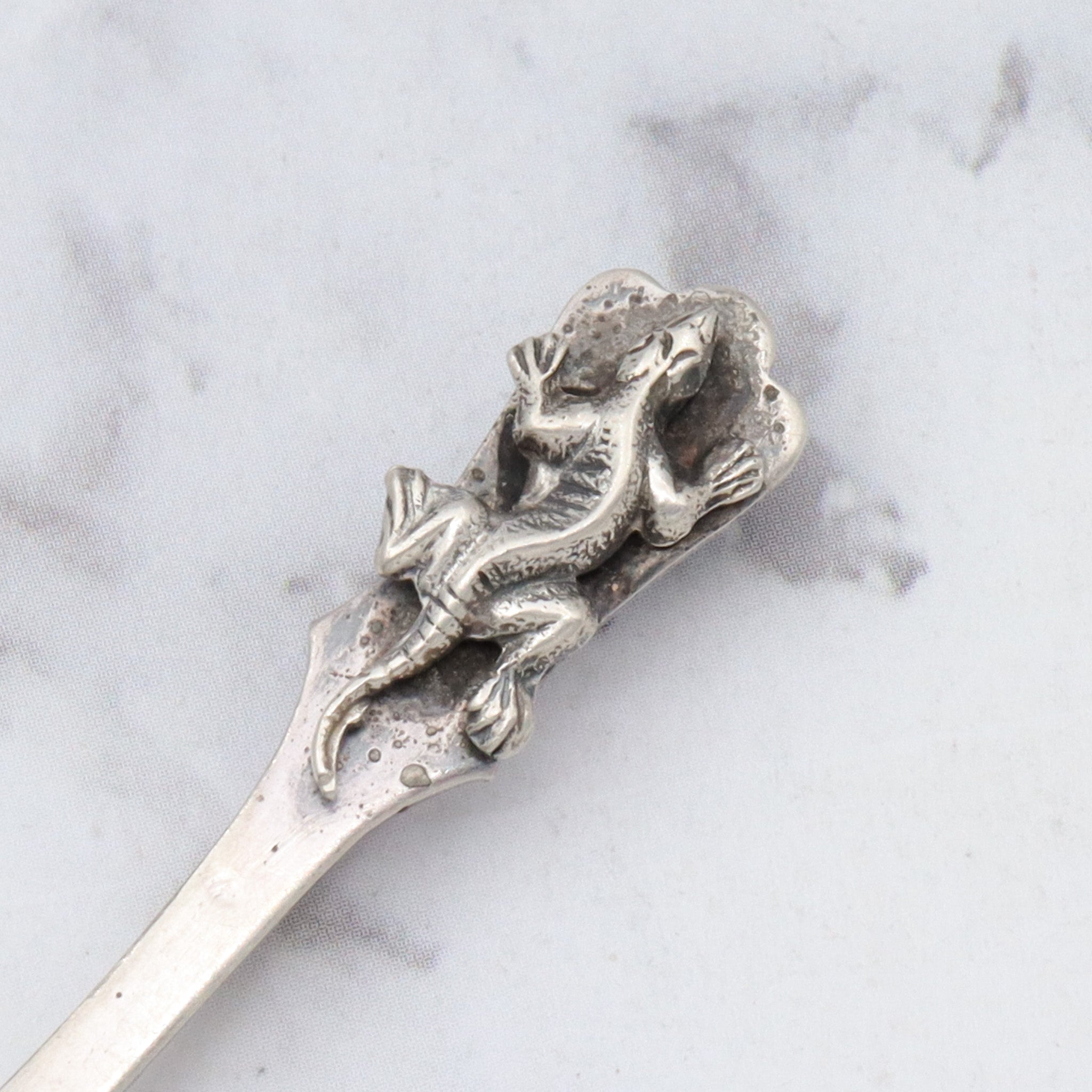 Antique sterling salt spoon brooch with figural lizard