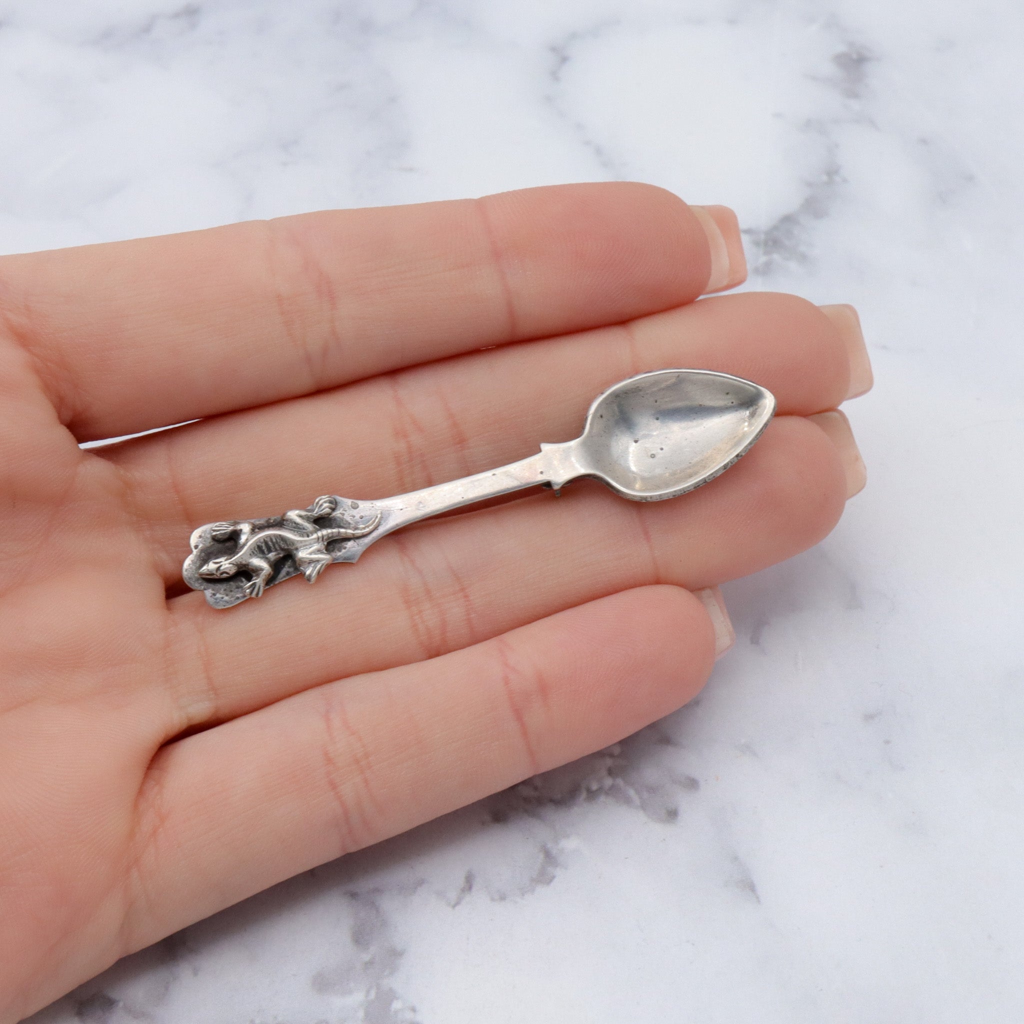 Antique sterling salt spoon brooch with figural lizard