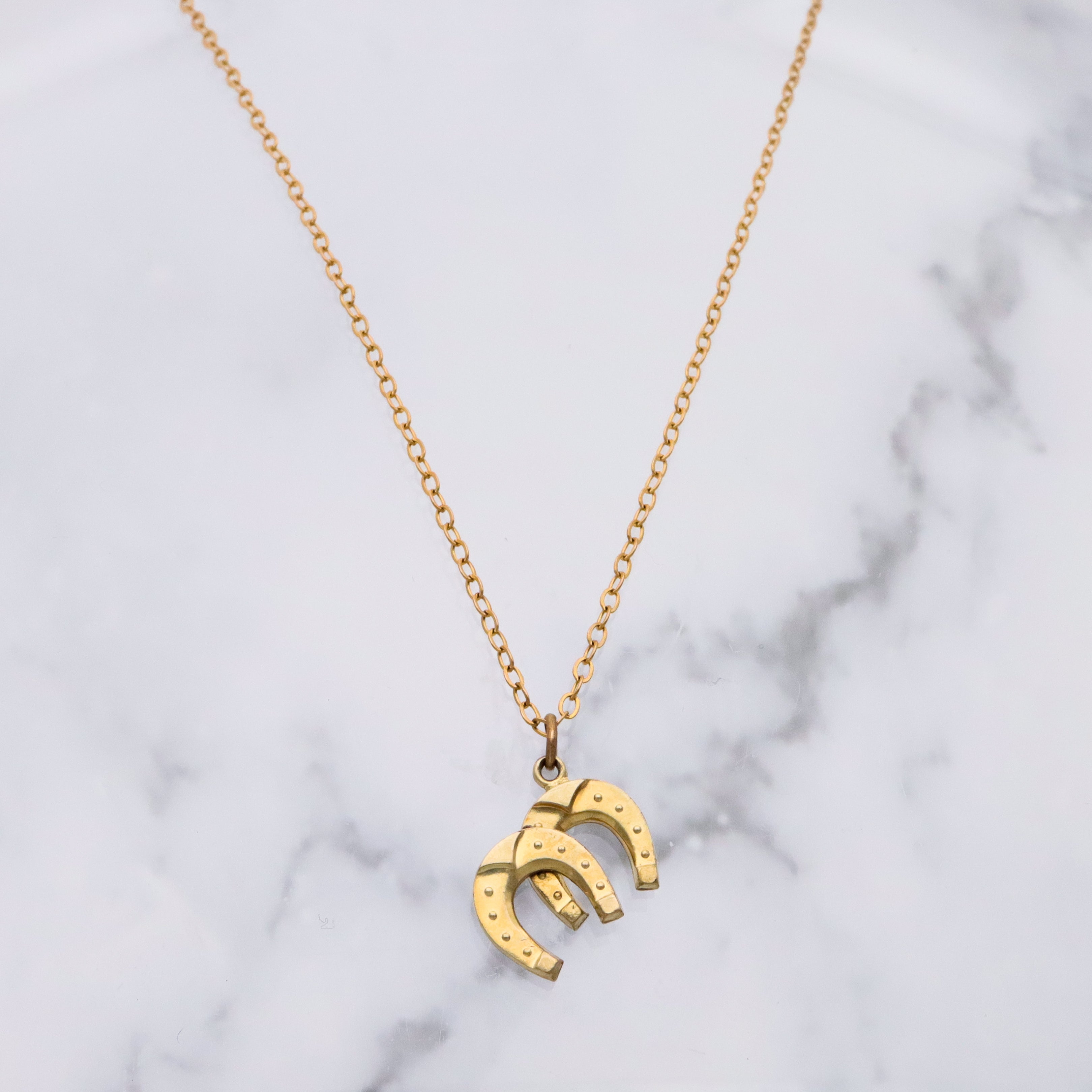 Antique rolled gold double horseshoe lucky charm pendant