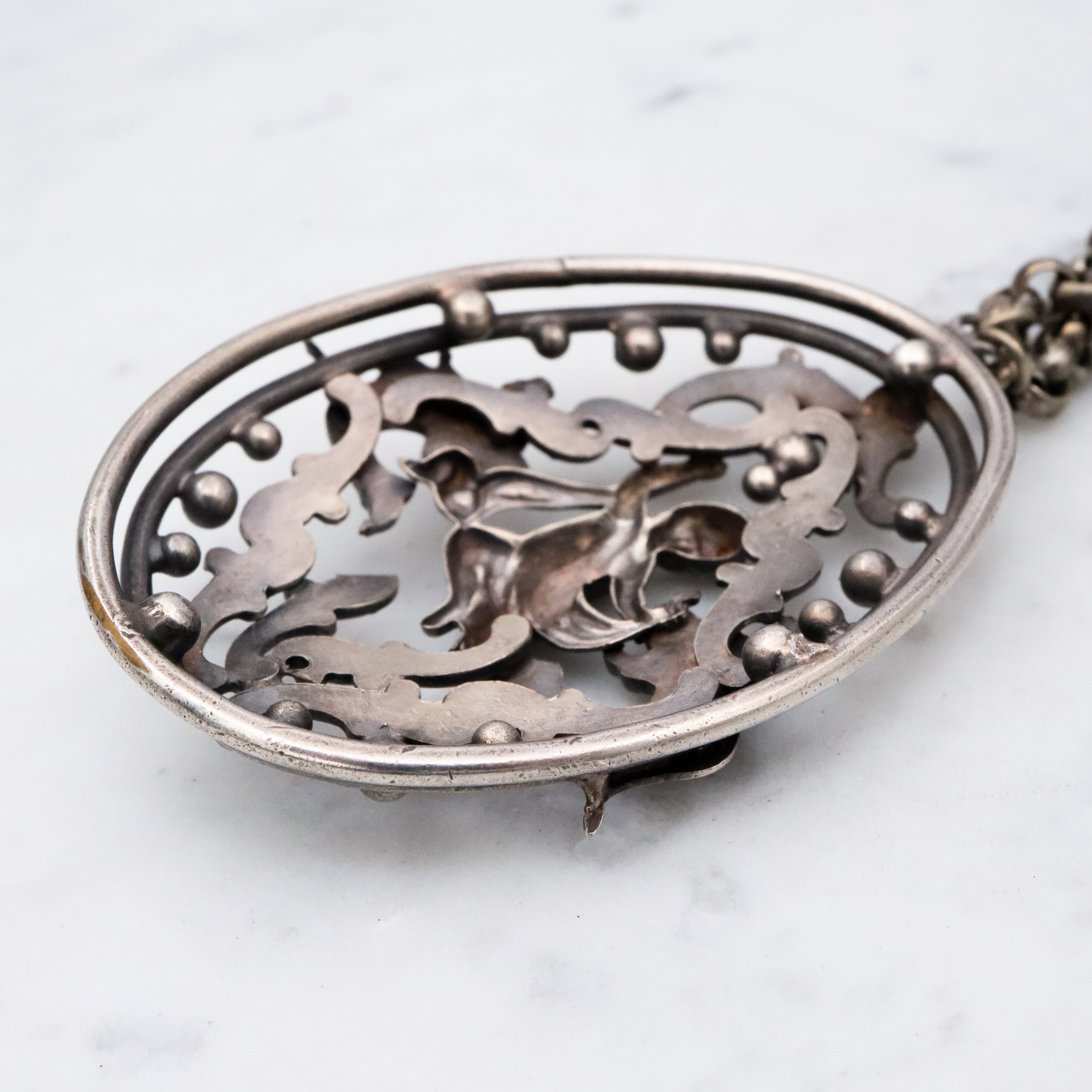 Antique Renaissance Revival silver plated putti & dragon cutout pendant necklace