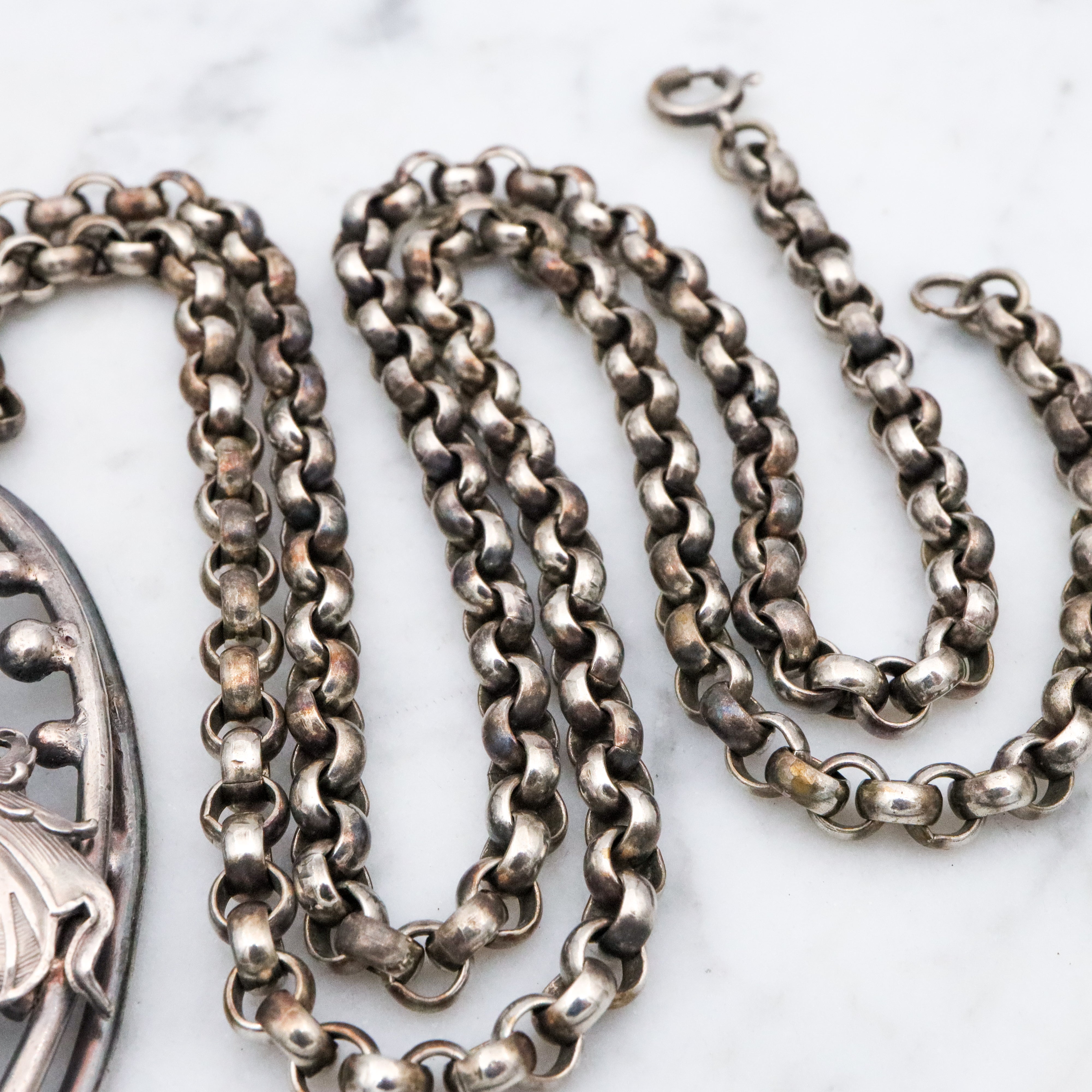 Antique Renaissance Revival silver plated putti & dragon cutout pendant necklace