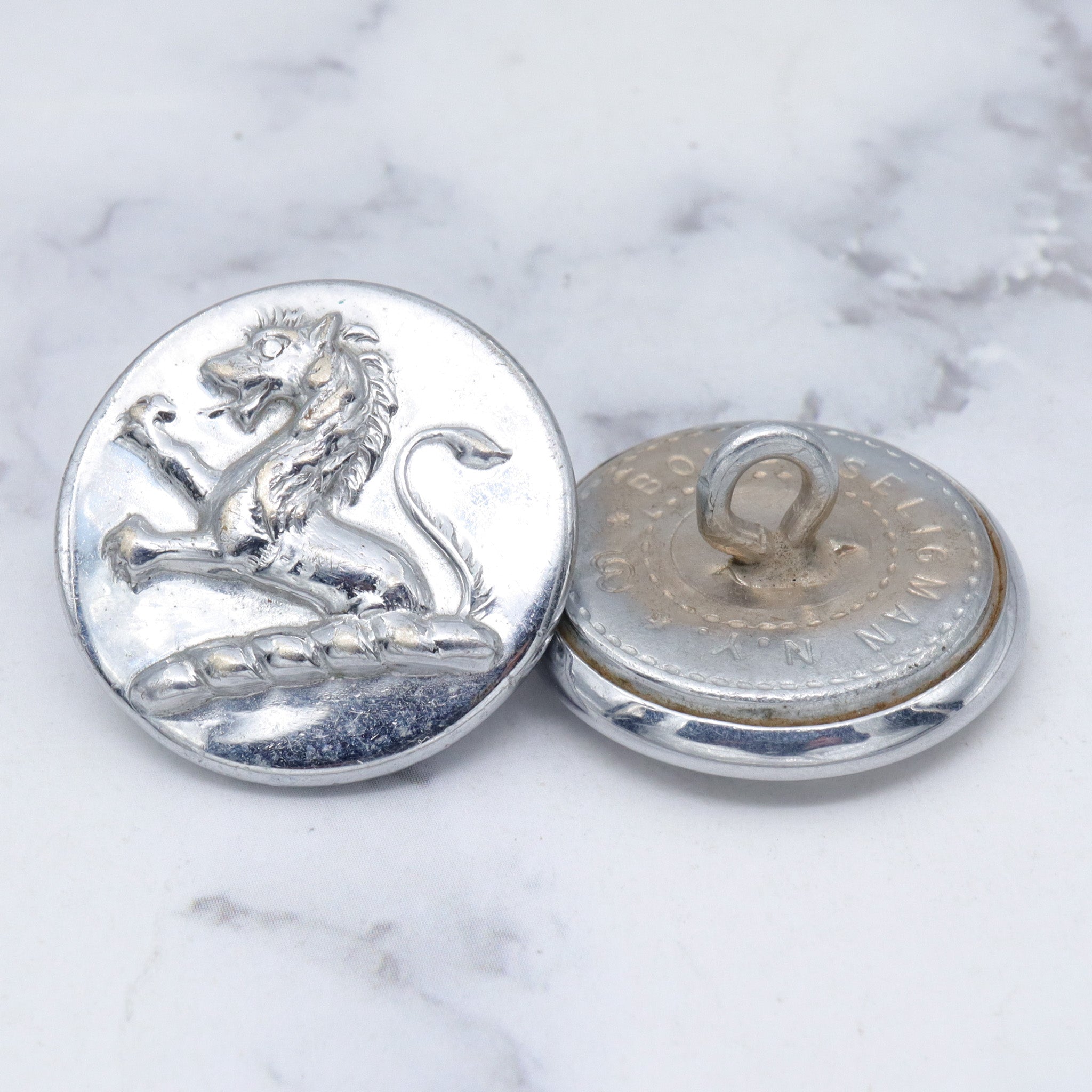 Large group of 28 Antique silver-plated brass livery buttons with rampant lion