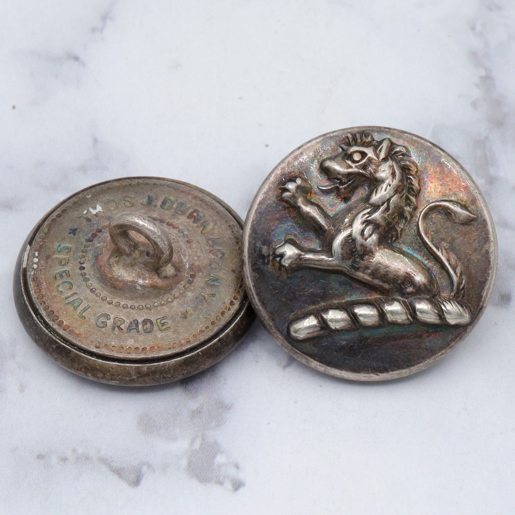 Large group of 28 Antique silver-plated brass livery buttons with rampant lion