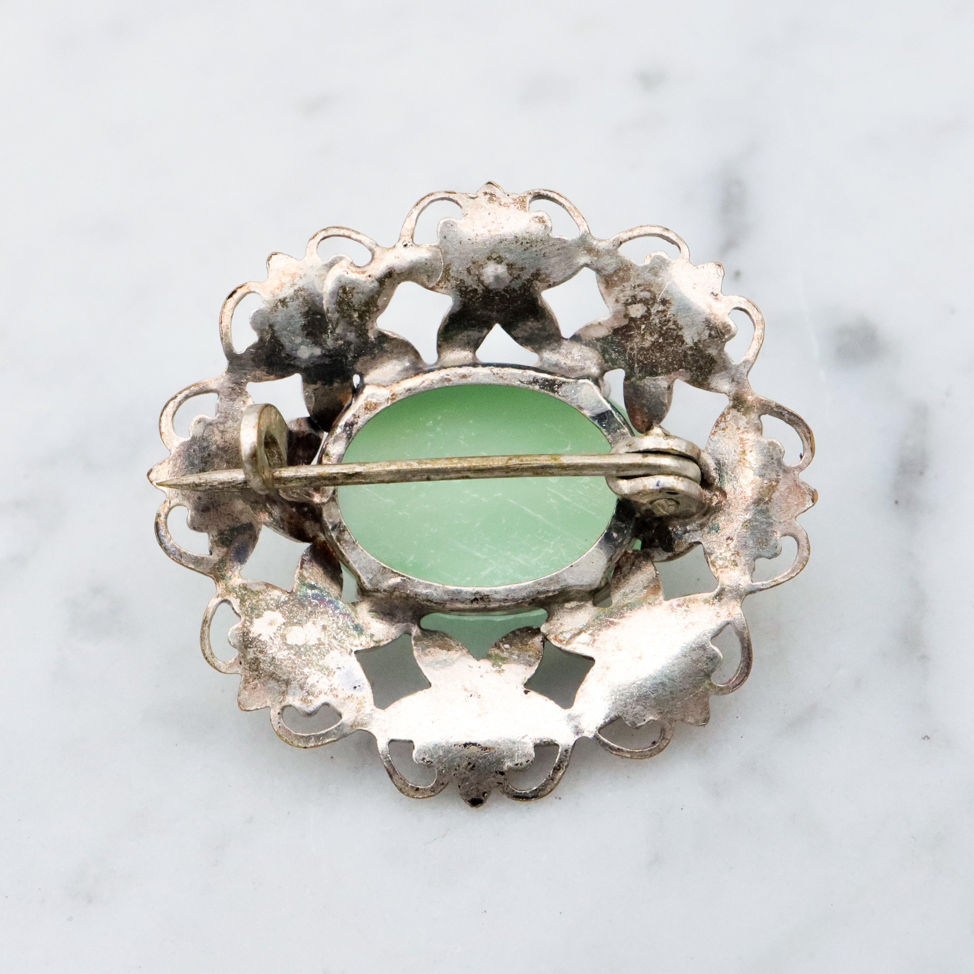 Antique Art Deco green cats eye enamel flower brooch