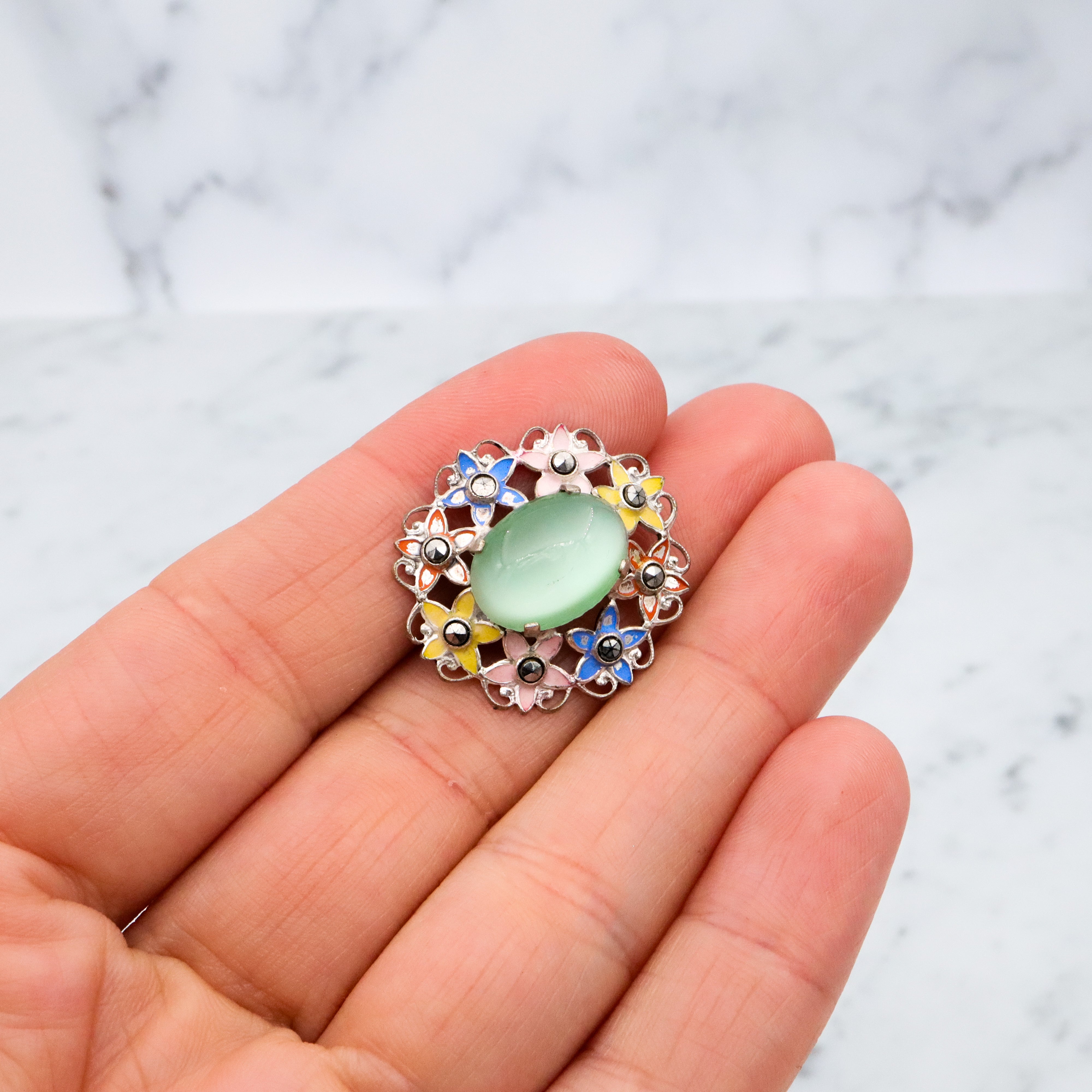 Antique Art Deco green cats eye enamel flower brooch