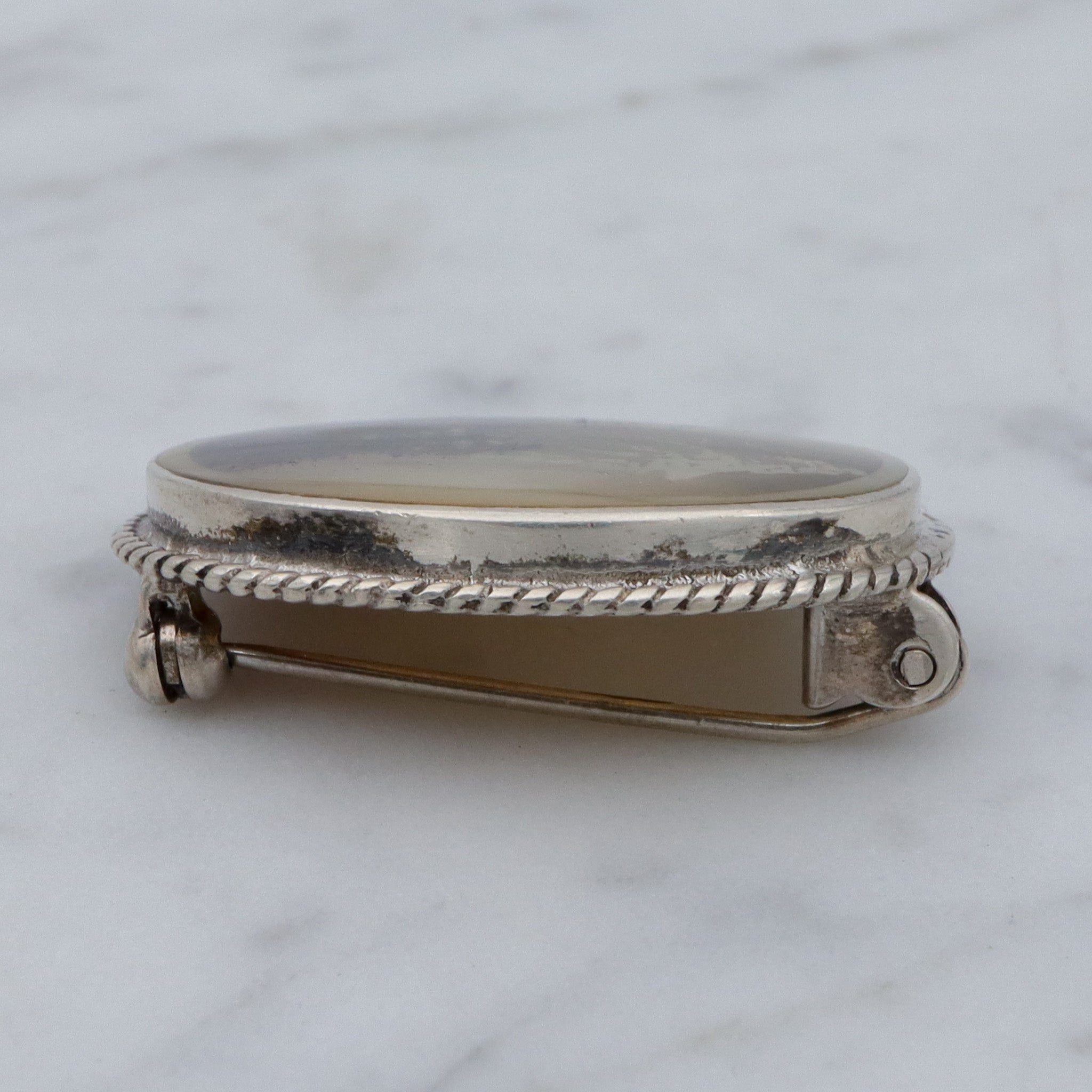 Vintage transfer printed miniature painting on mother of pearl and sterling brooch