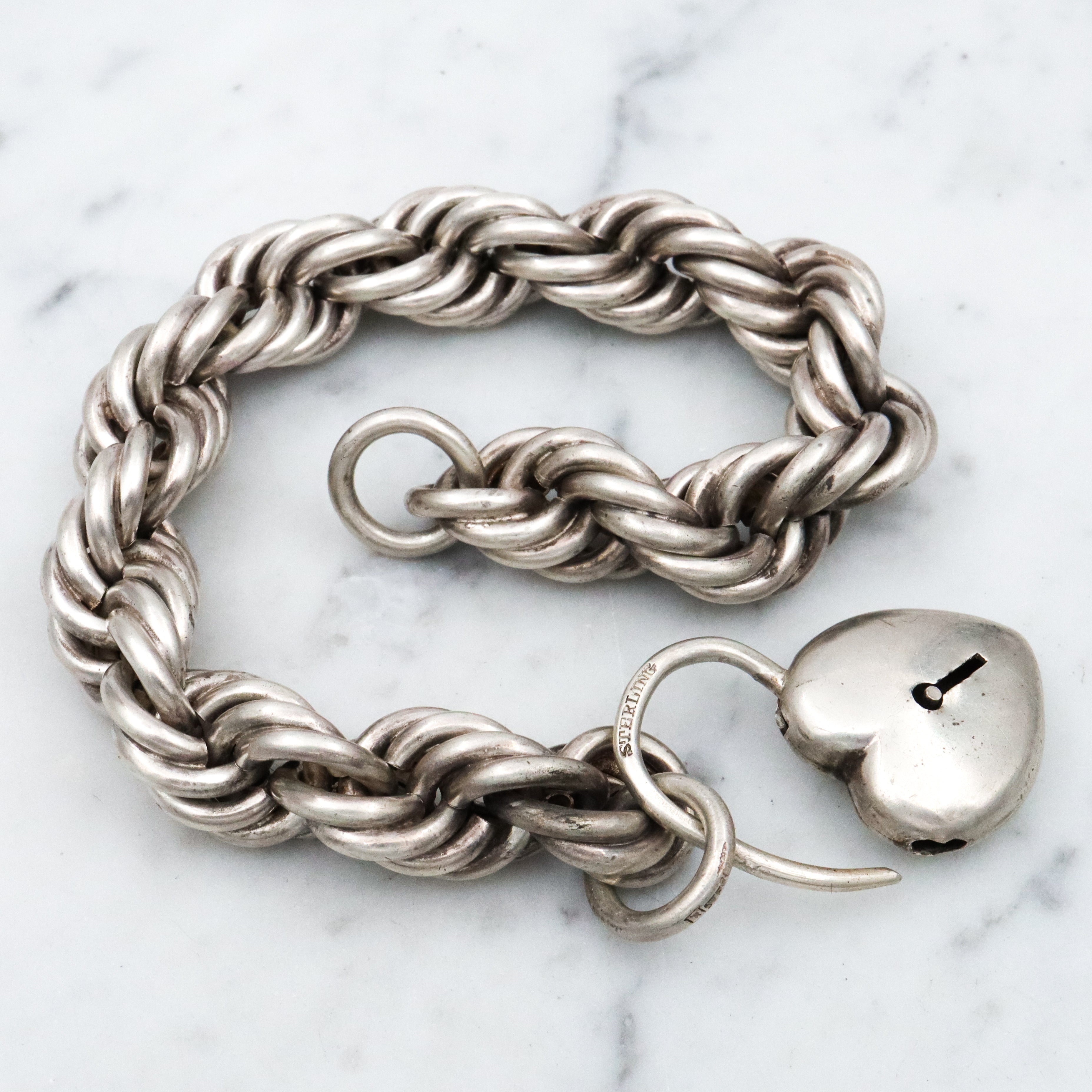 Rare Edwardian sterling Simons Bros thick rope bracelet with heart padlock