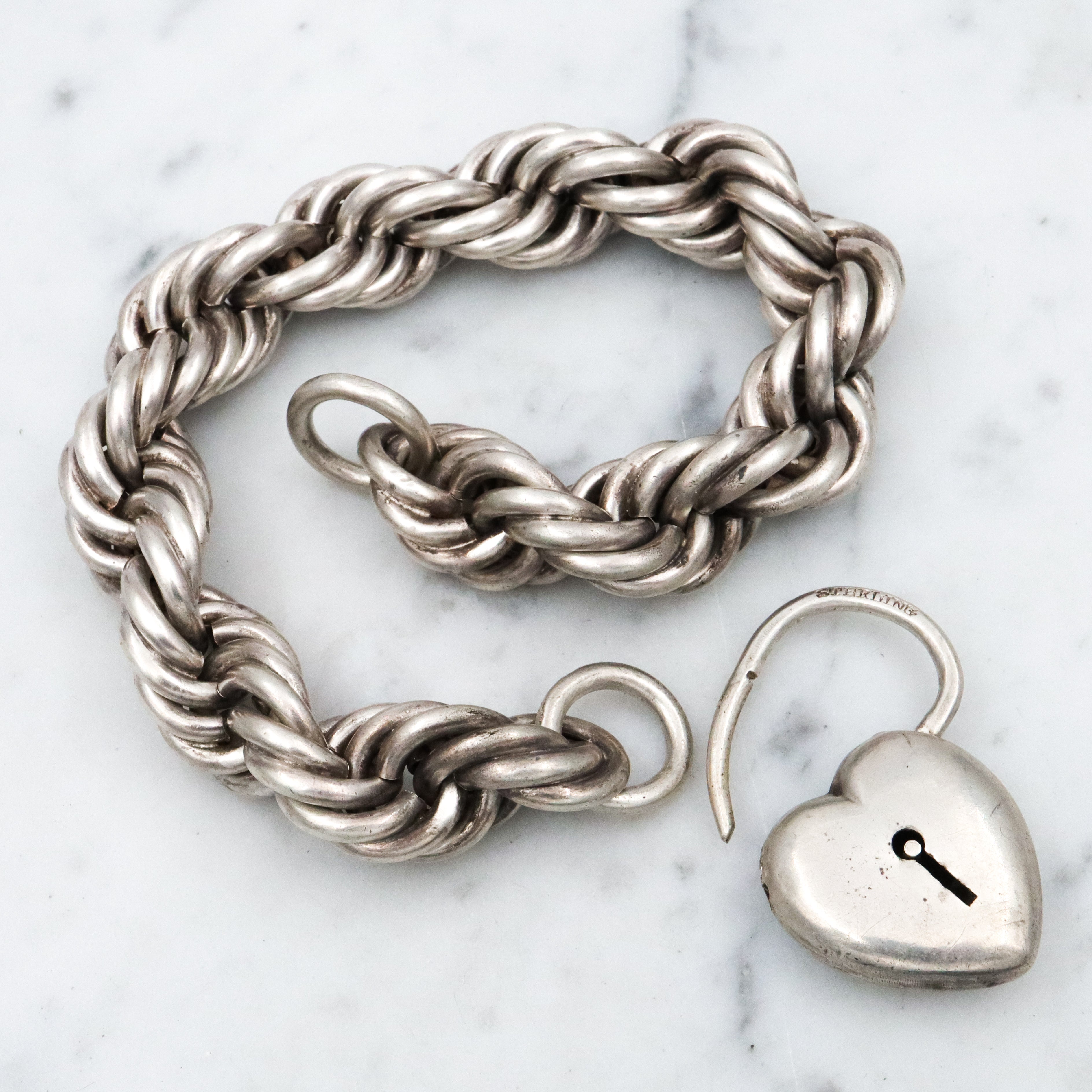 Rare Edwardian sterling Simons Bros thick rope bracelet with heart padlock