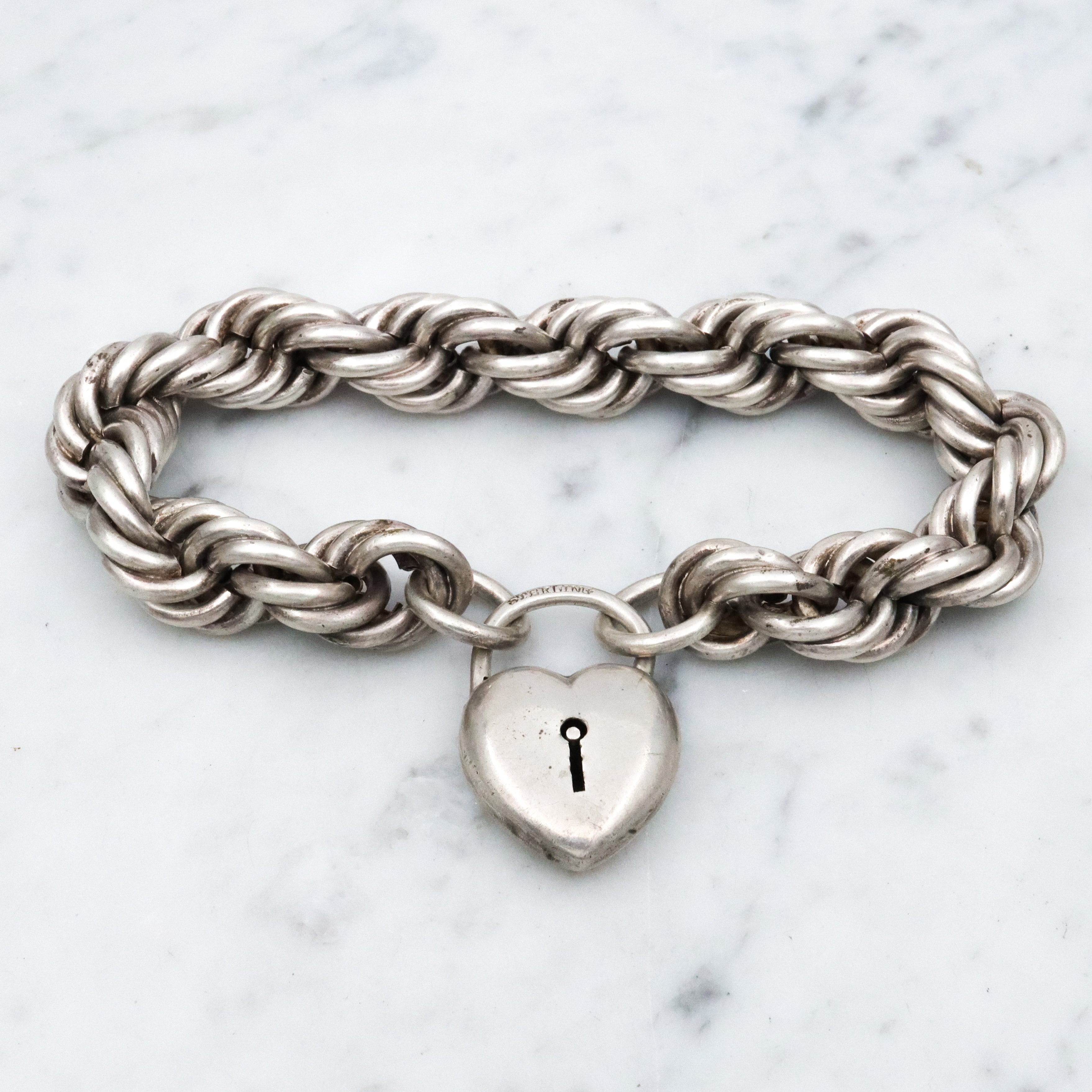 Rare Edwardian sterling Simons Bros thick rope bracelet with heart padlock