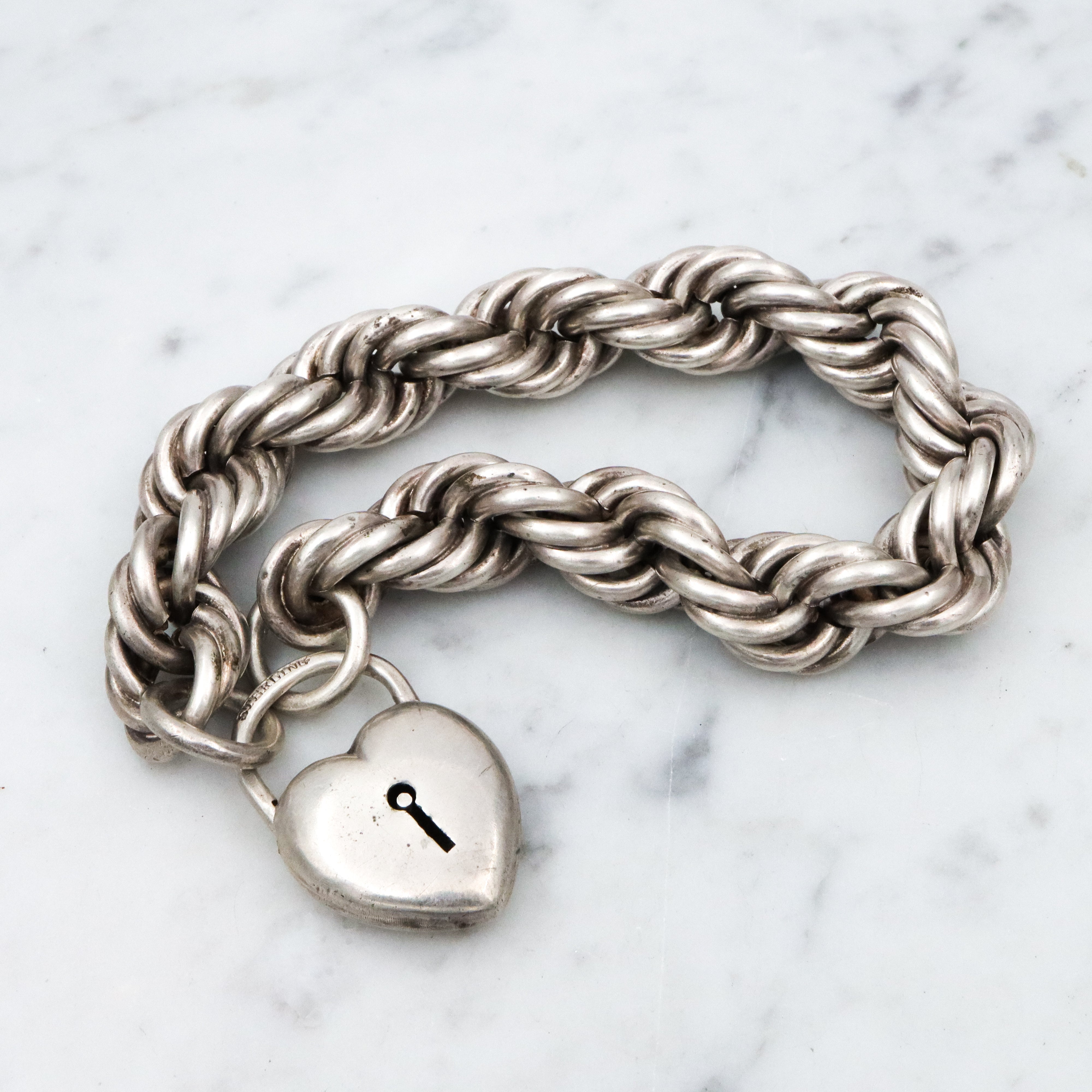Rare Edwardian sterling Simons Bros thick rope bracelet with heart padlock