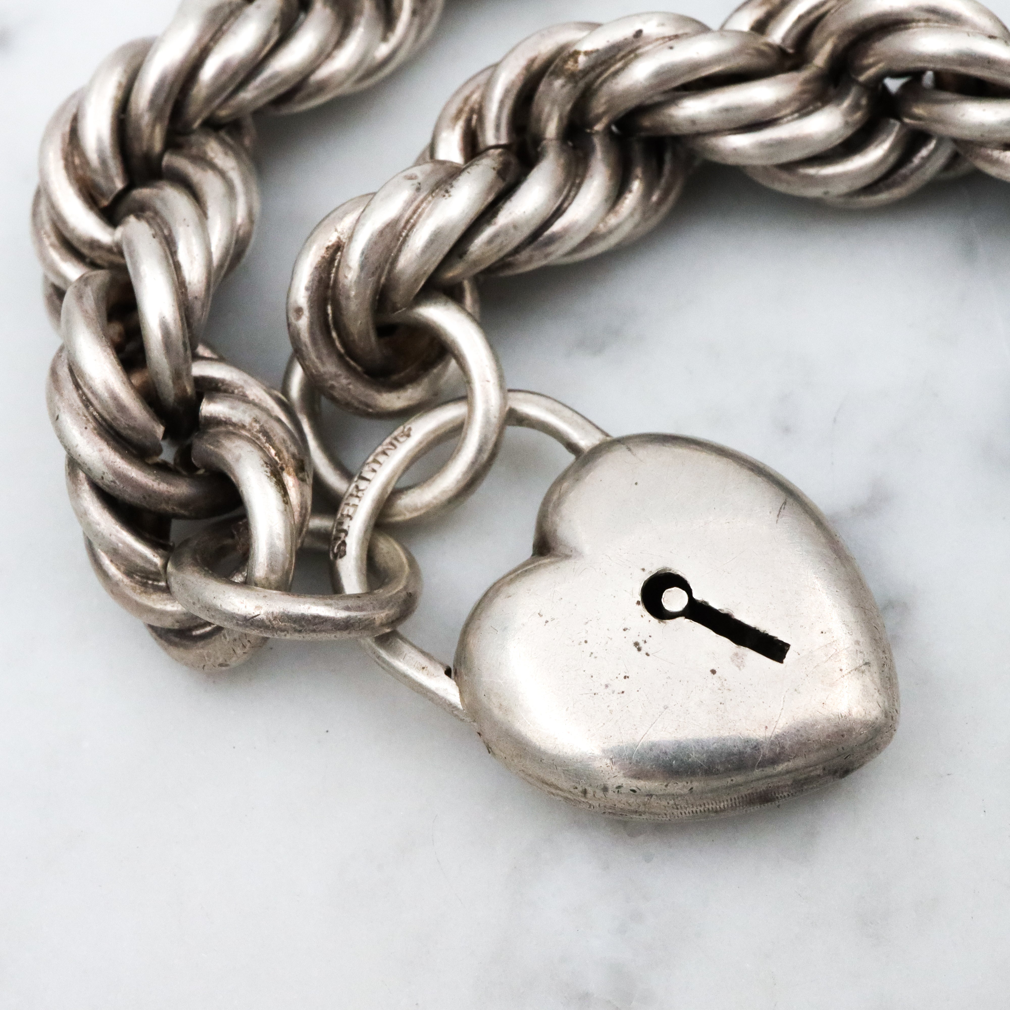 Rare Edwardian sterling Simons Bros thick rope bracelet with heart padlock