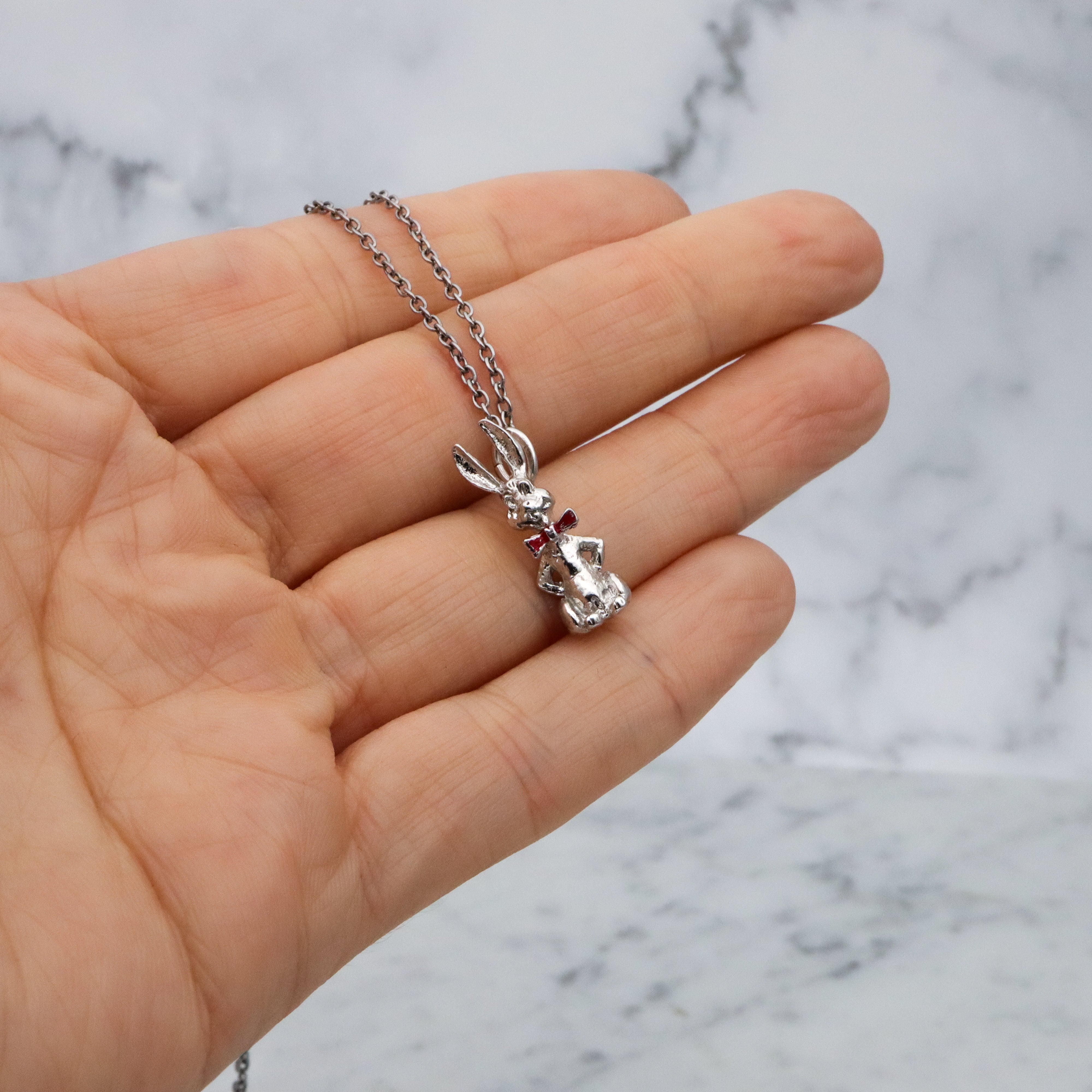 Vintage sterling seated bunny with red bowtie & nodding head