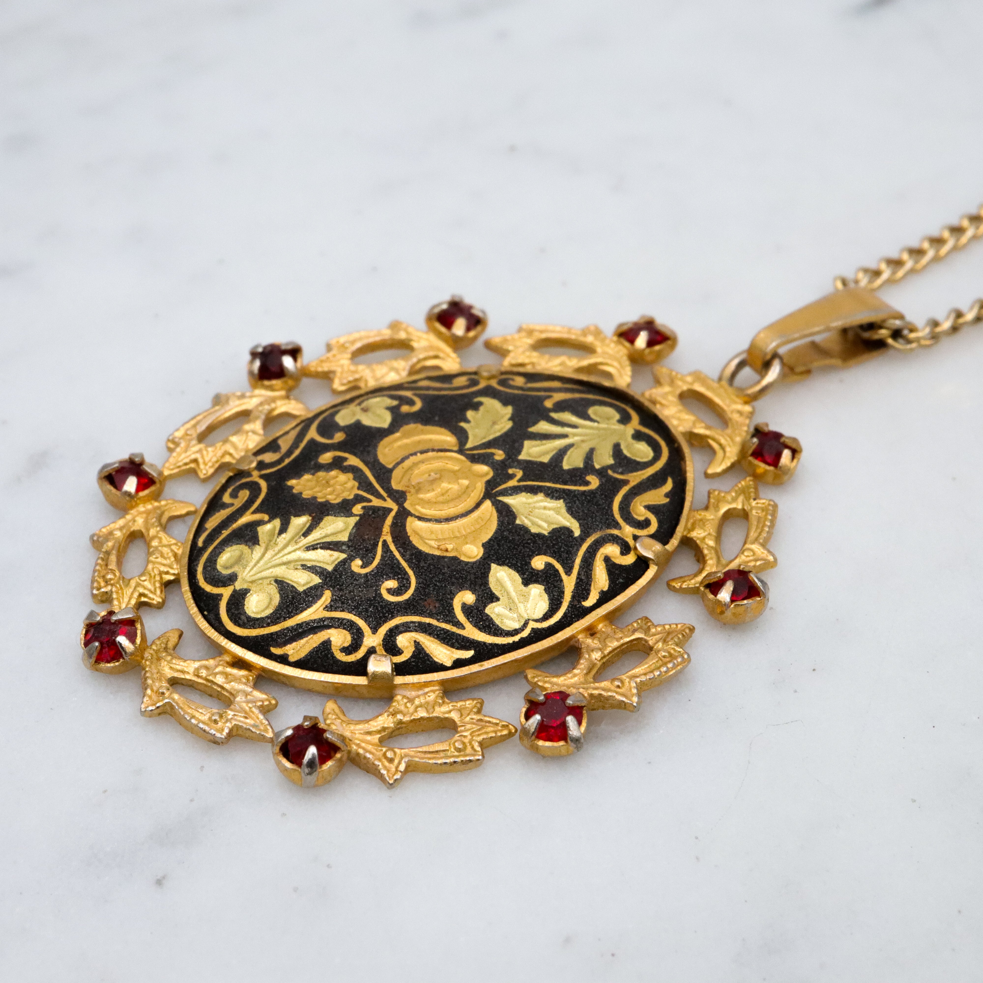 Mid Century Spanish damascene floral pendant with red rhinestone accents