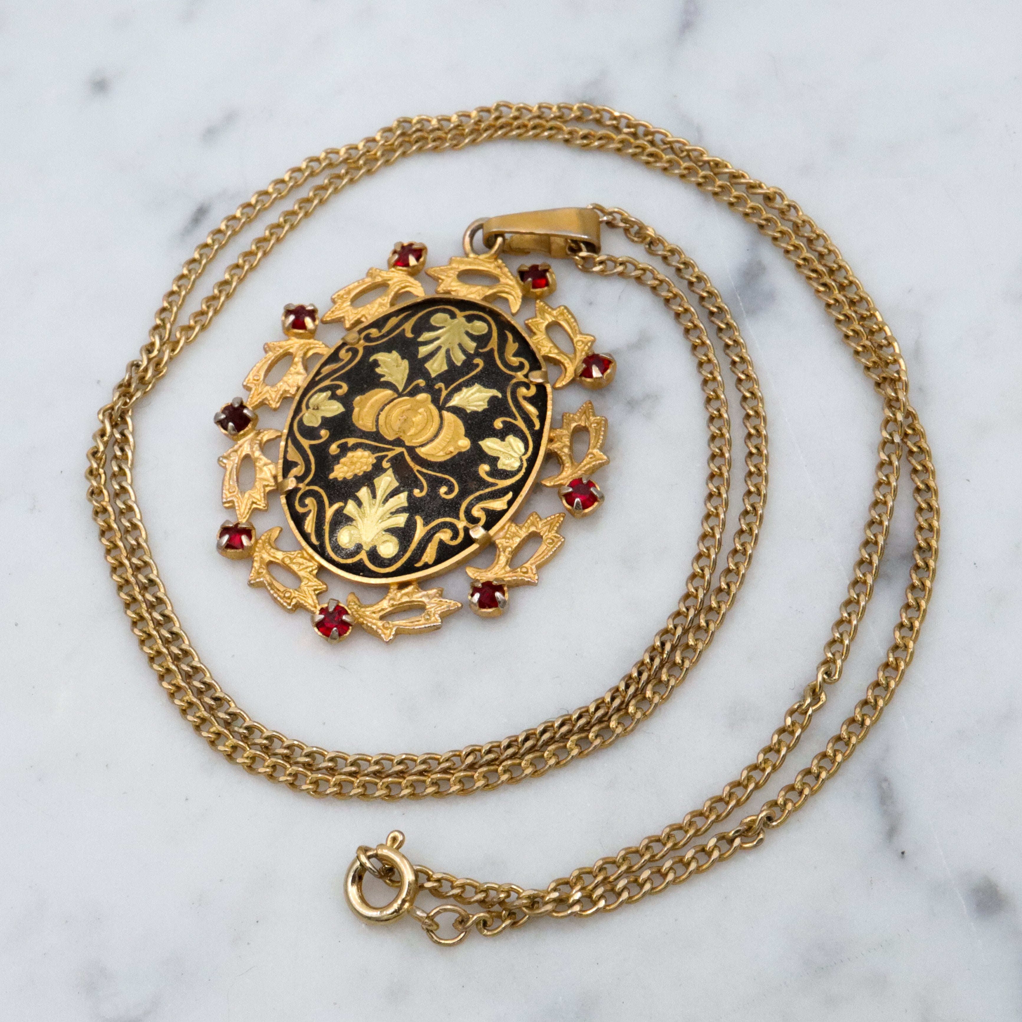 Mid Century Spanish damascene floral pendant with red rhinestone accents