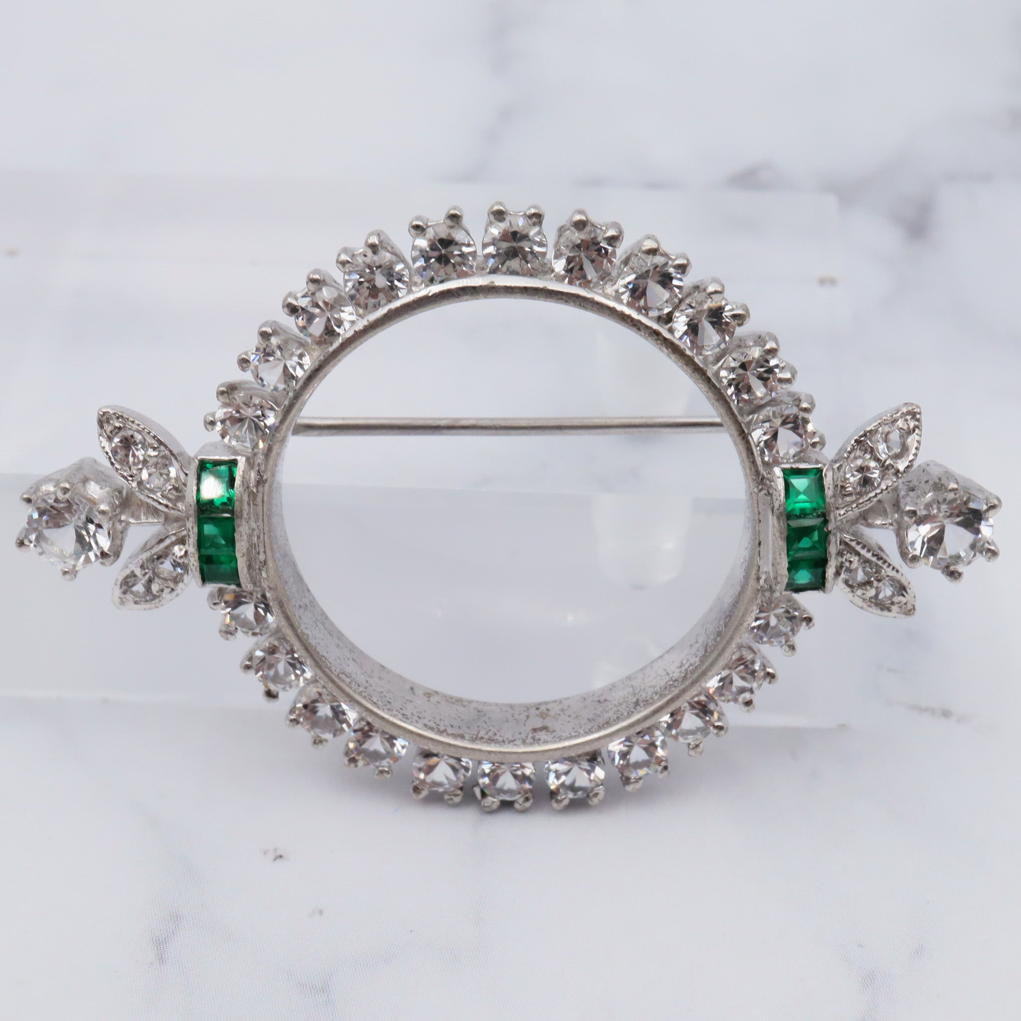 Antique Art Deco rhodium plated sterling, quartz & synthetic emerald circle frame brooch