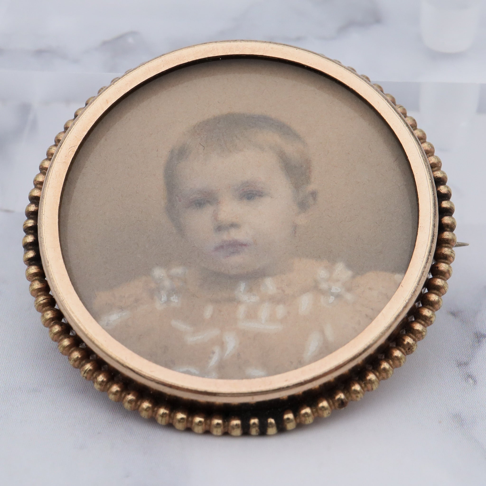 Antique Victorian gold-filled circle brooch with hand painted child’s portrait