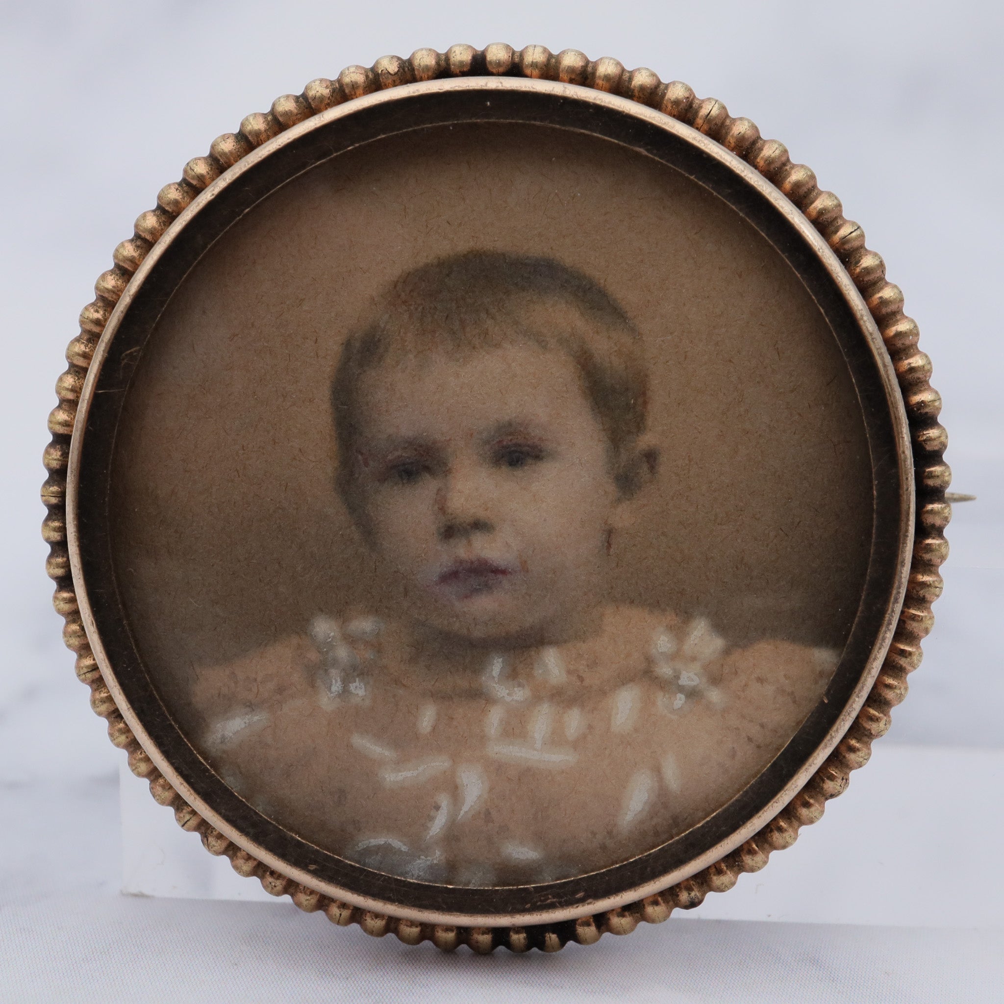 Antique Victorian gold-filled circle brooch with hand painted child’s portrait