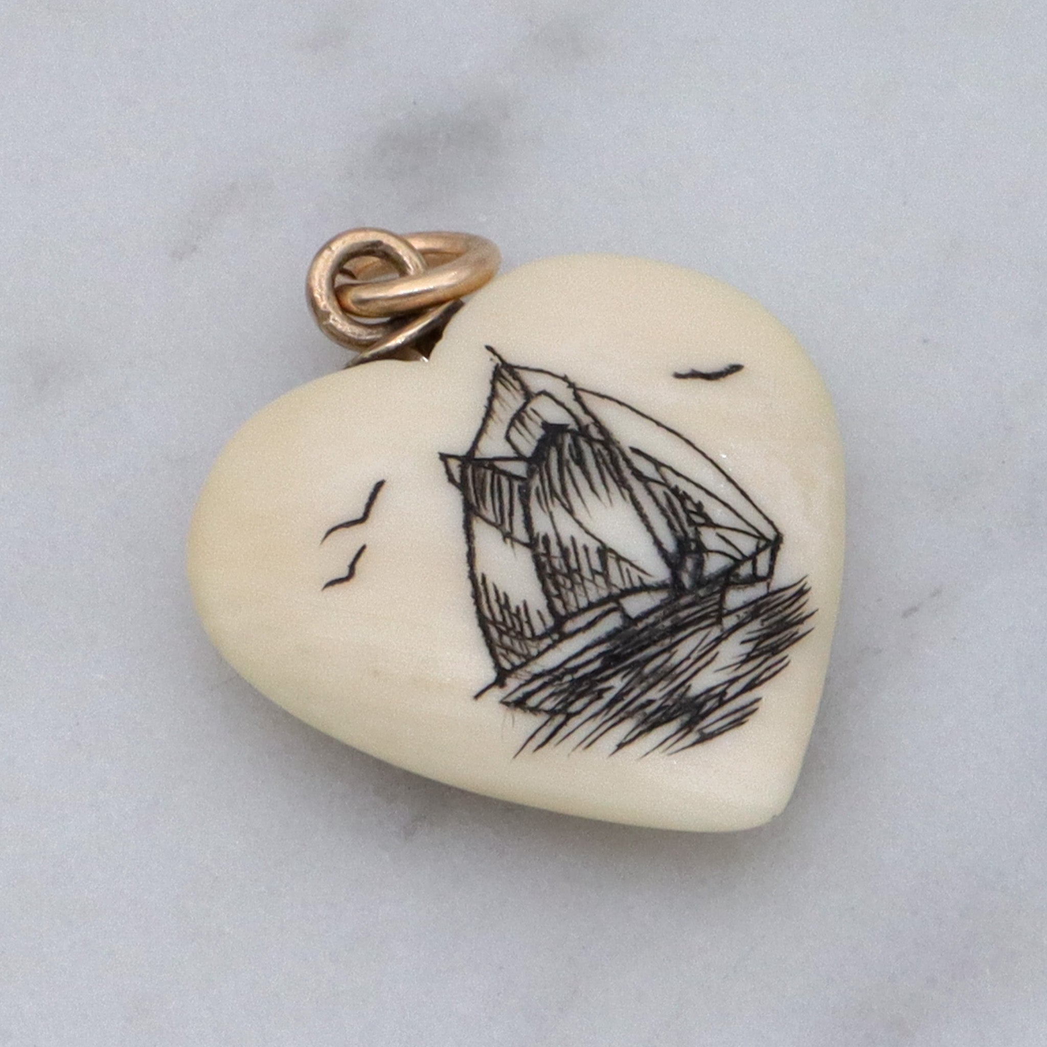 Antique hand carved faux ivory sailboat heart charm pendant