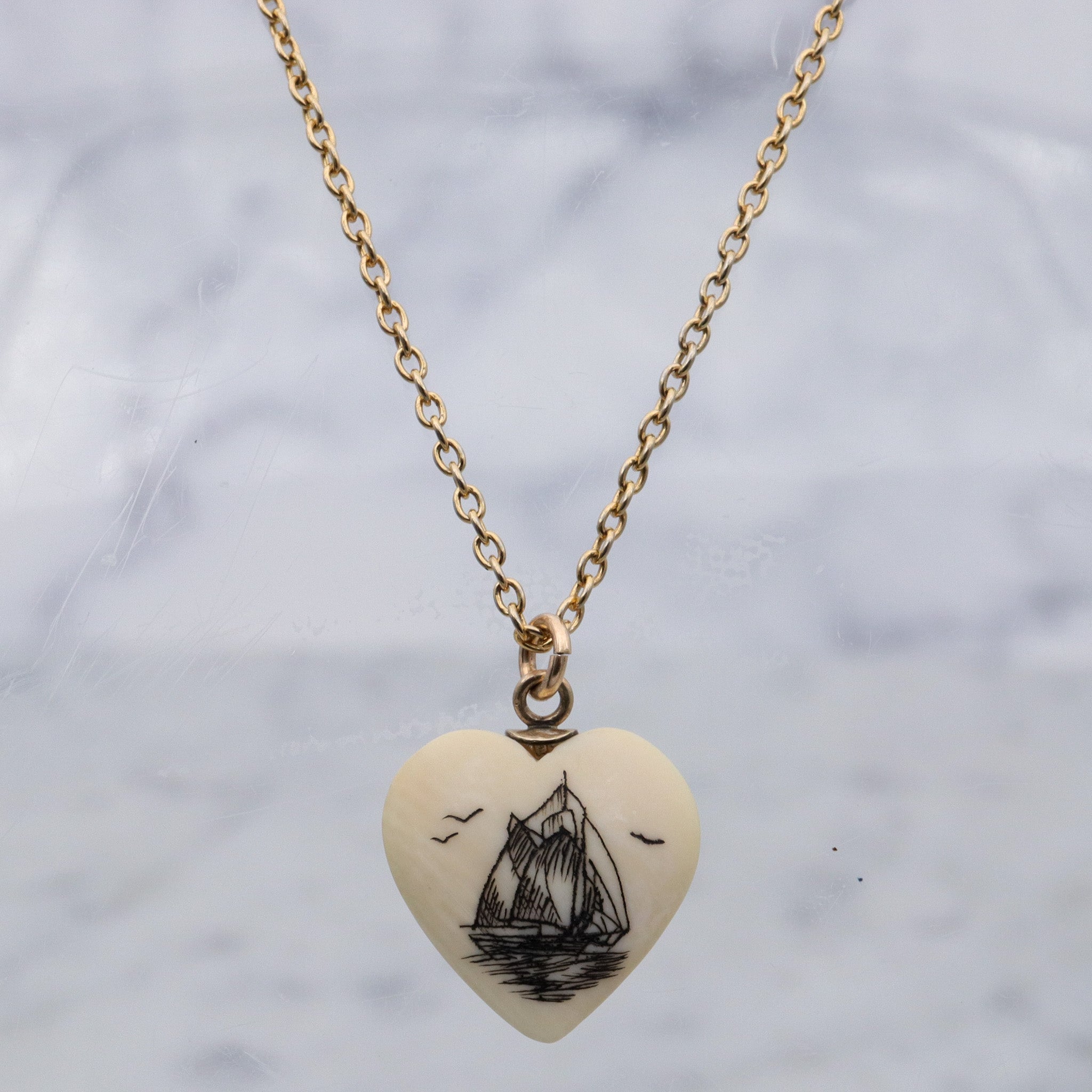Antique hand carved faux ivory sailboat heart charm pendant