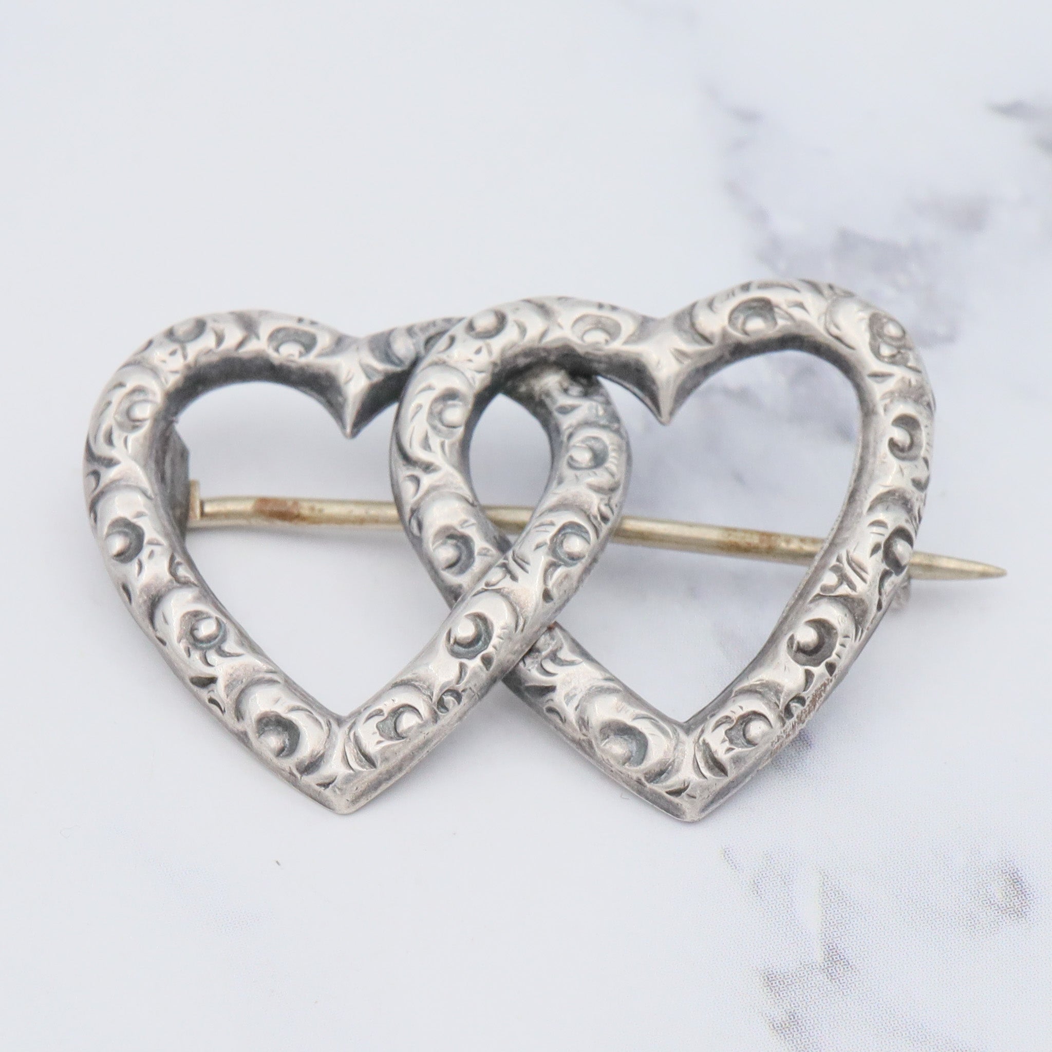 Antique Victorian sterling repousse double heart brooch