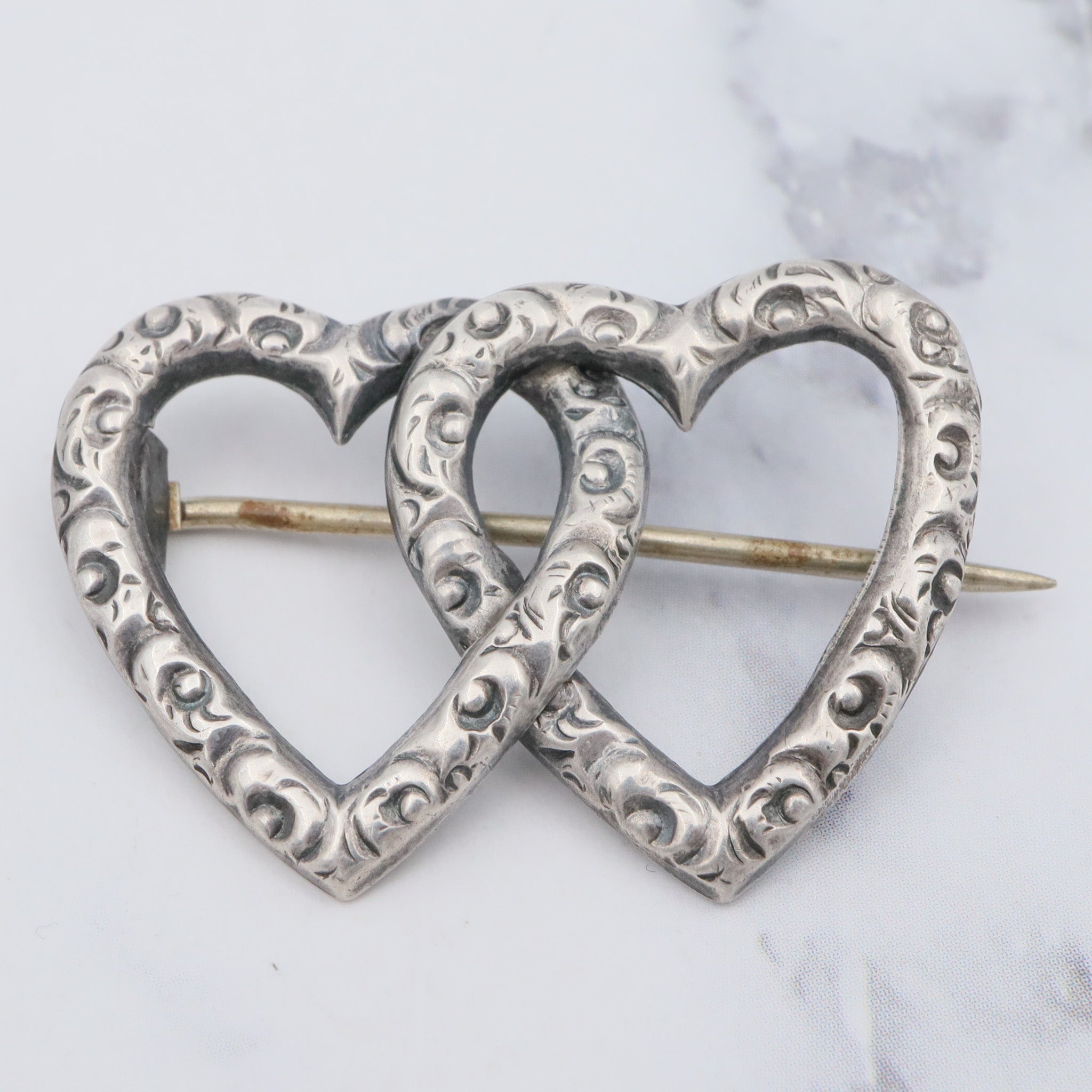 Antique Victorian sterling repousse double heart brooch