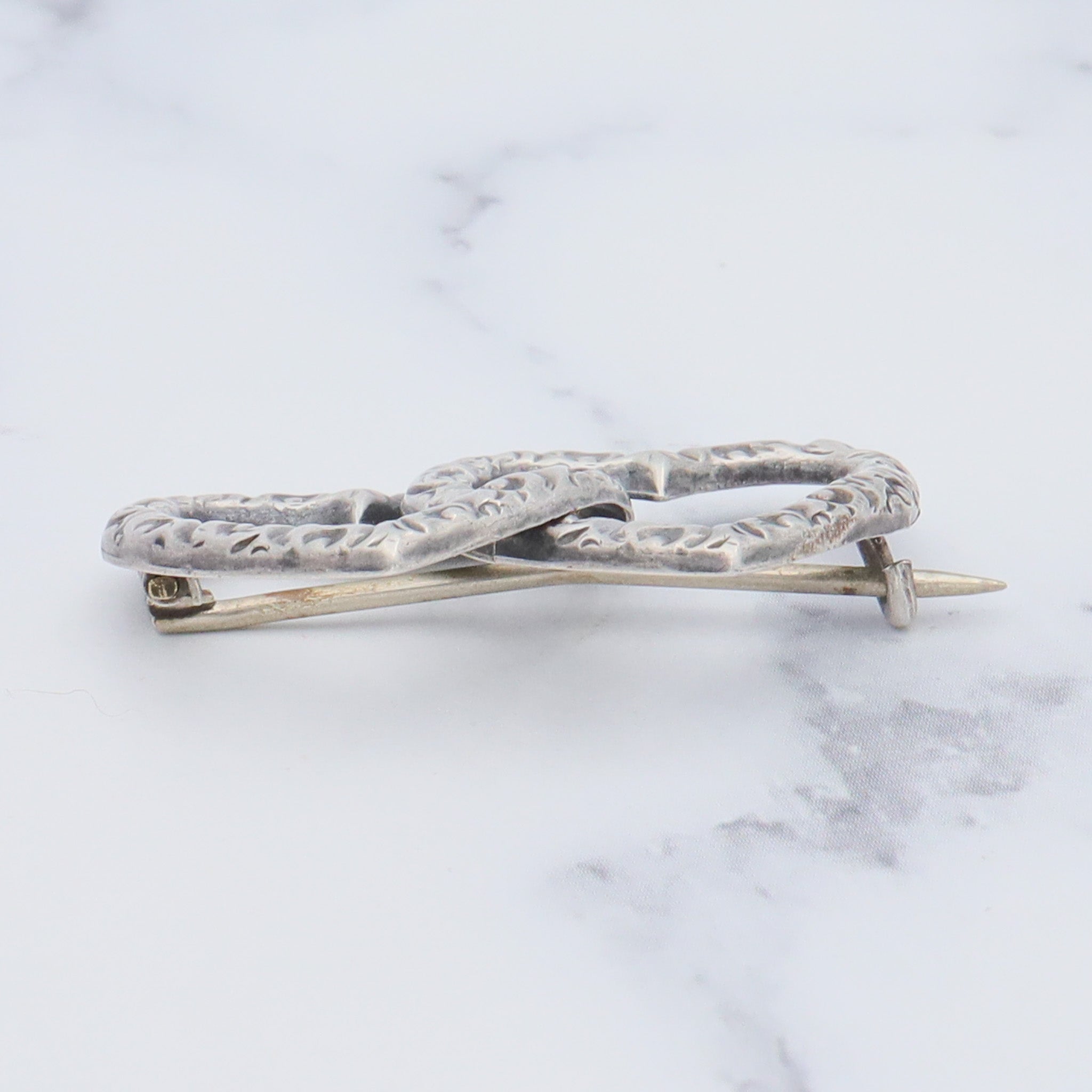 Antique Victorian sterling repousse double heart brooch