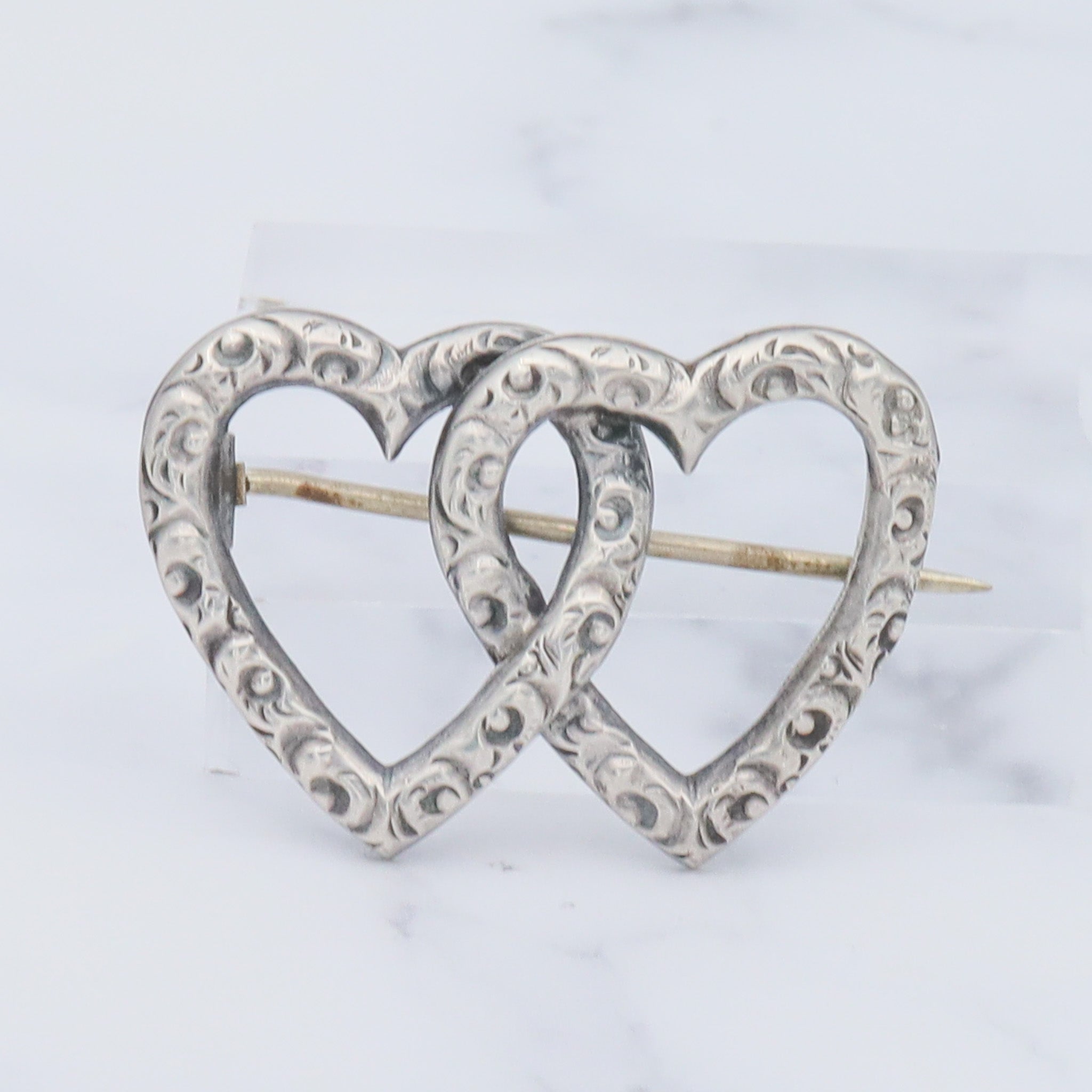 Antique Victorian sterling repousse double heart brooch