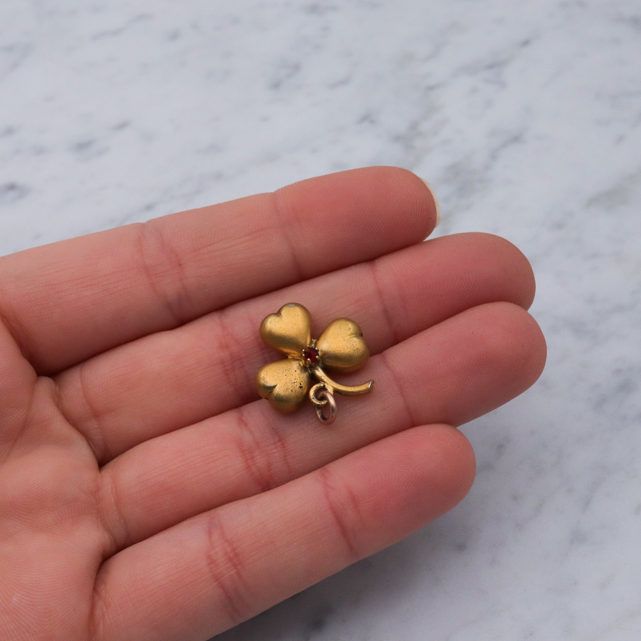 Antique Victorian gilt metal clover with faux garnet pendant