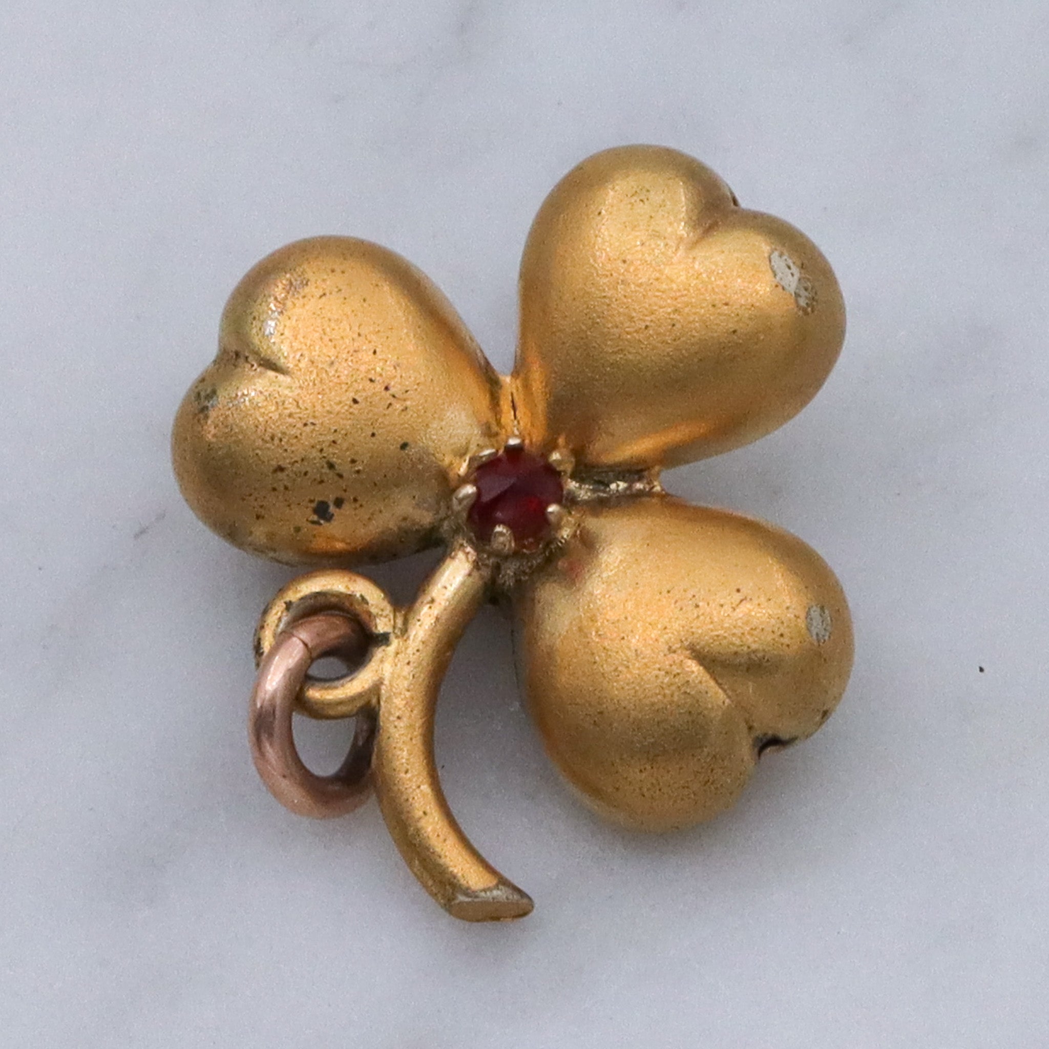Antique Victorian gilt metal clover with faux garnet pendant