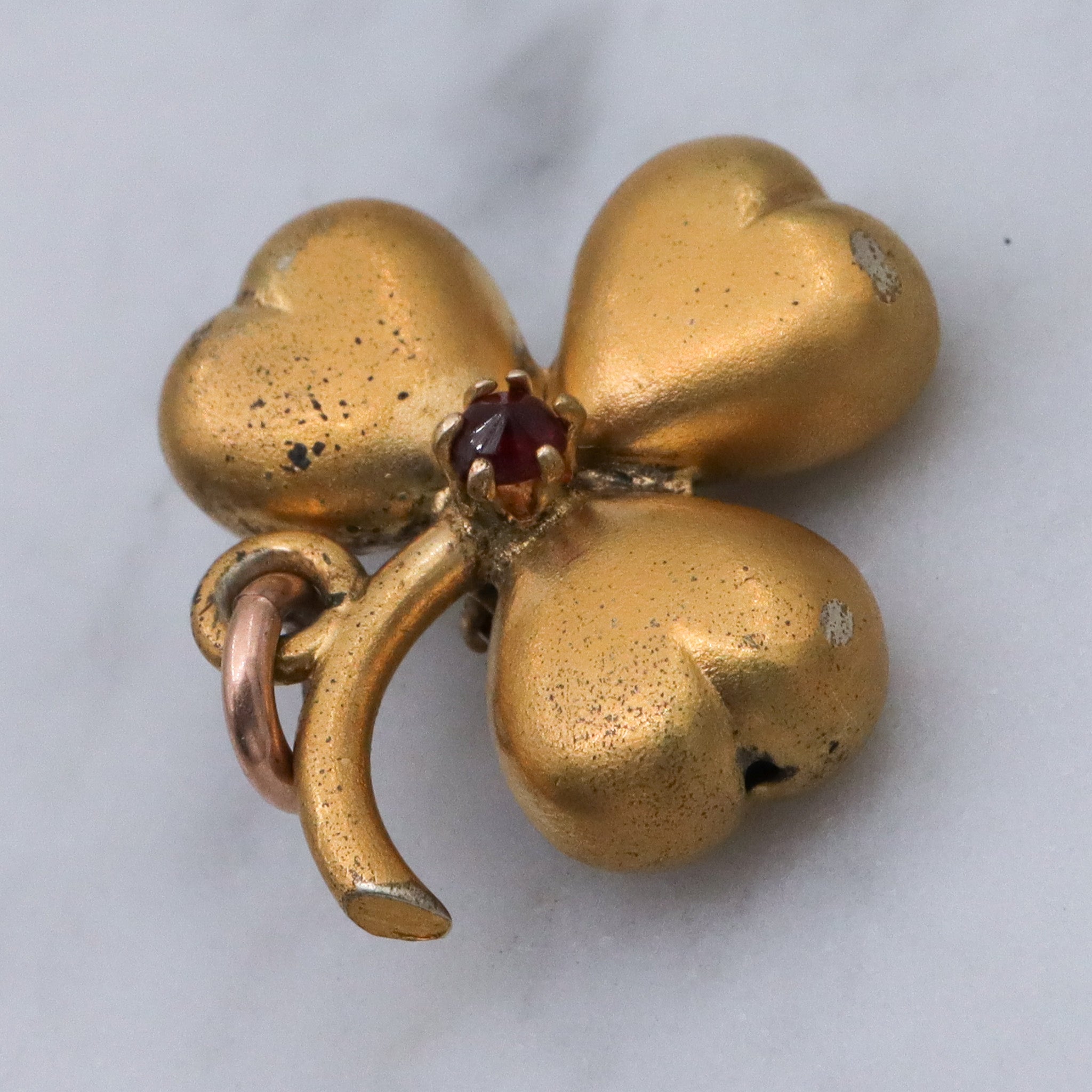 Antique Victorian gilt metal clover with faux garnet pendant