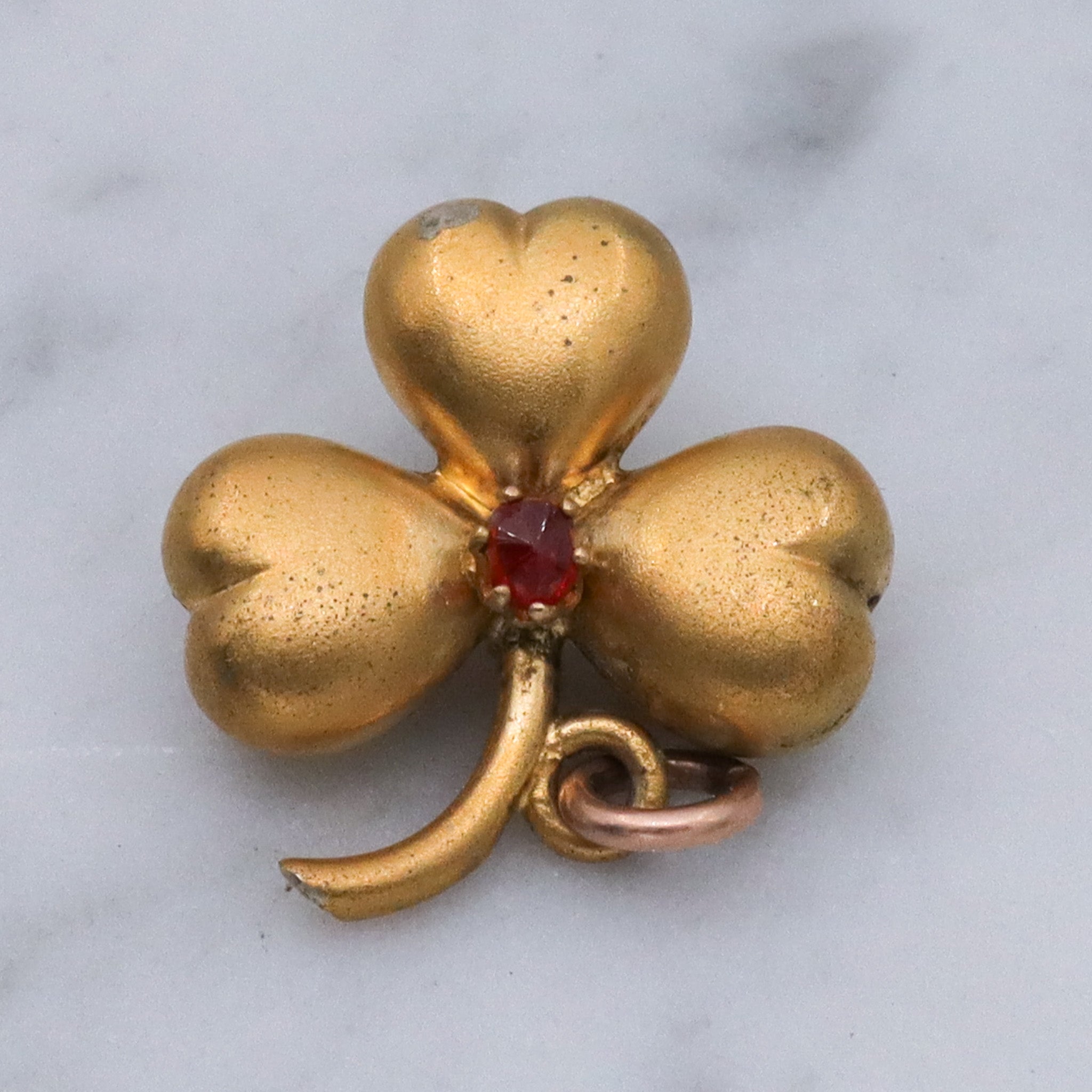 Antique Victorian gilt metal clover with faux garnet pendant