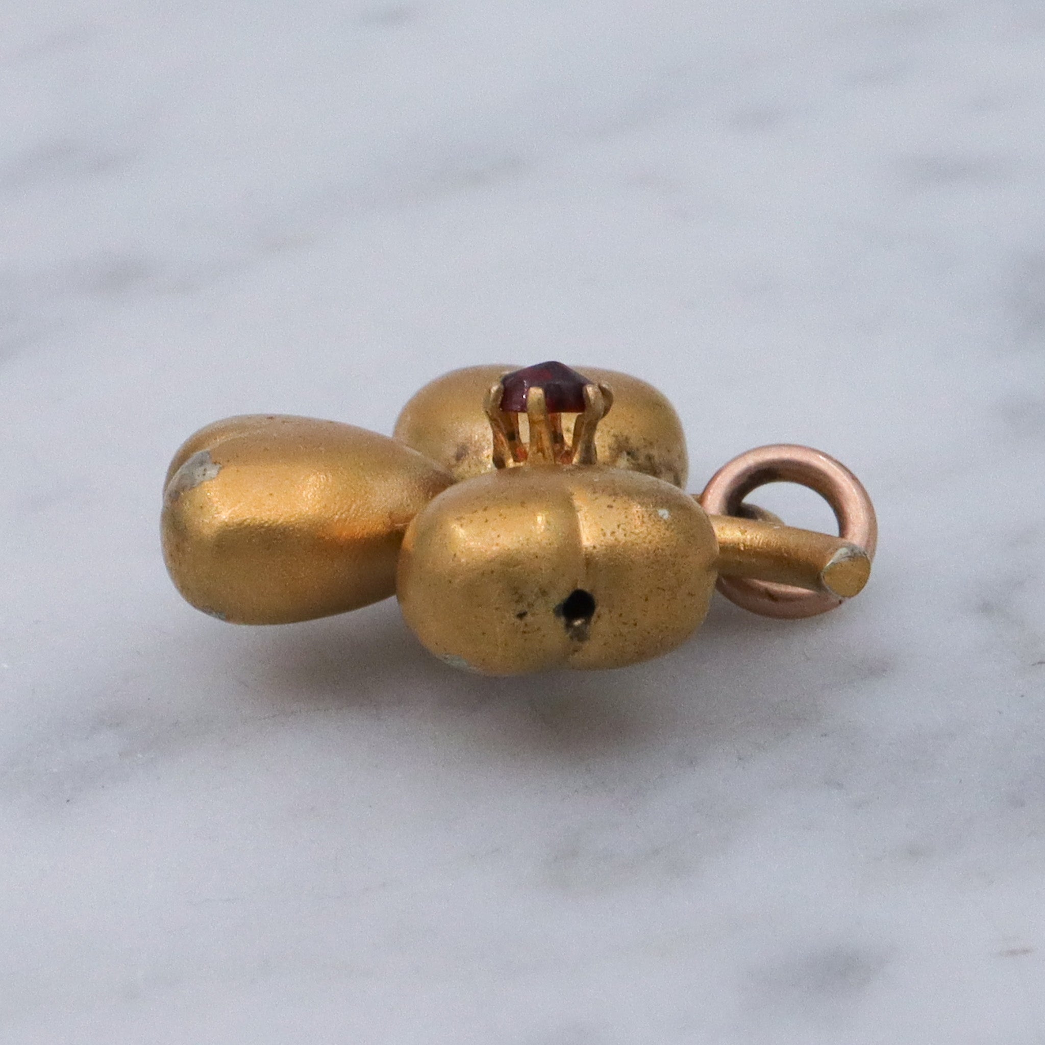 Antique Victorian gilt metal clover with faux garnet pendant