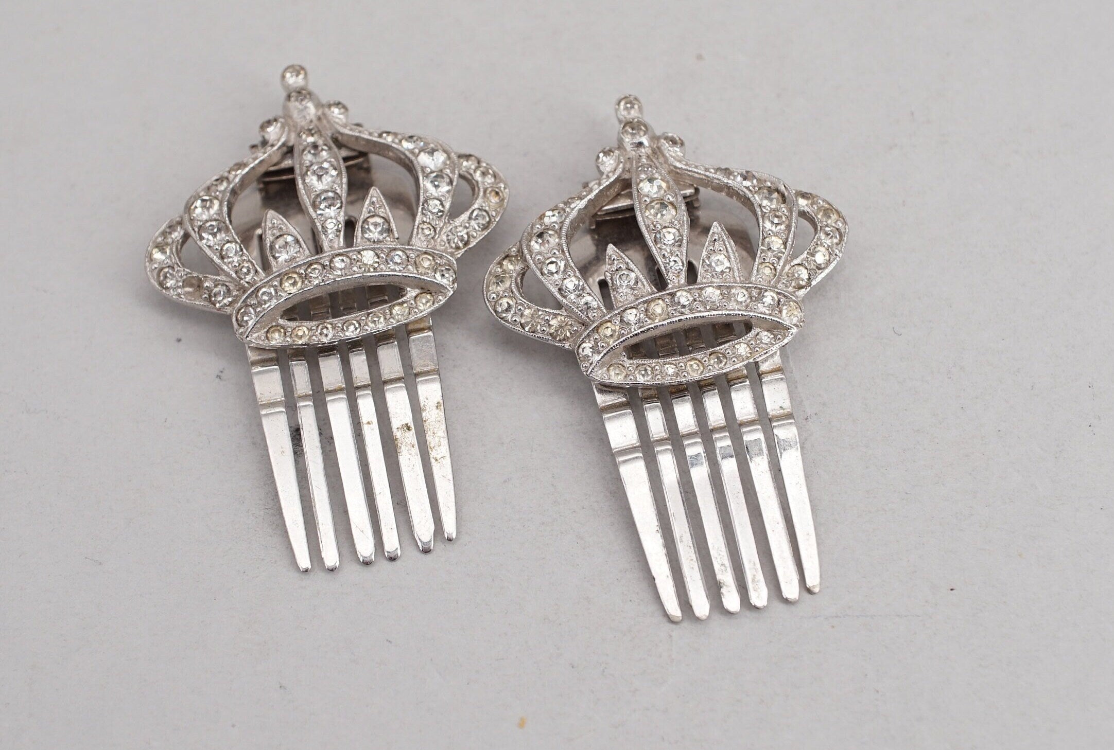 pair of coro silver tone rhinestone crown hair comb clips