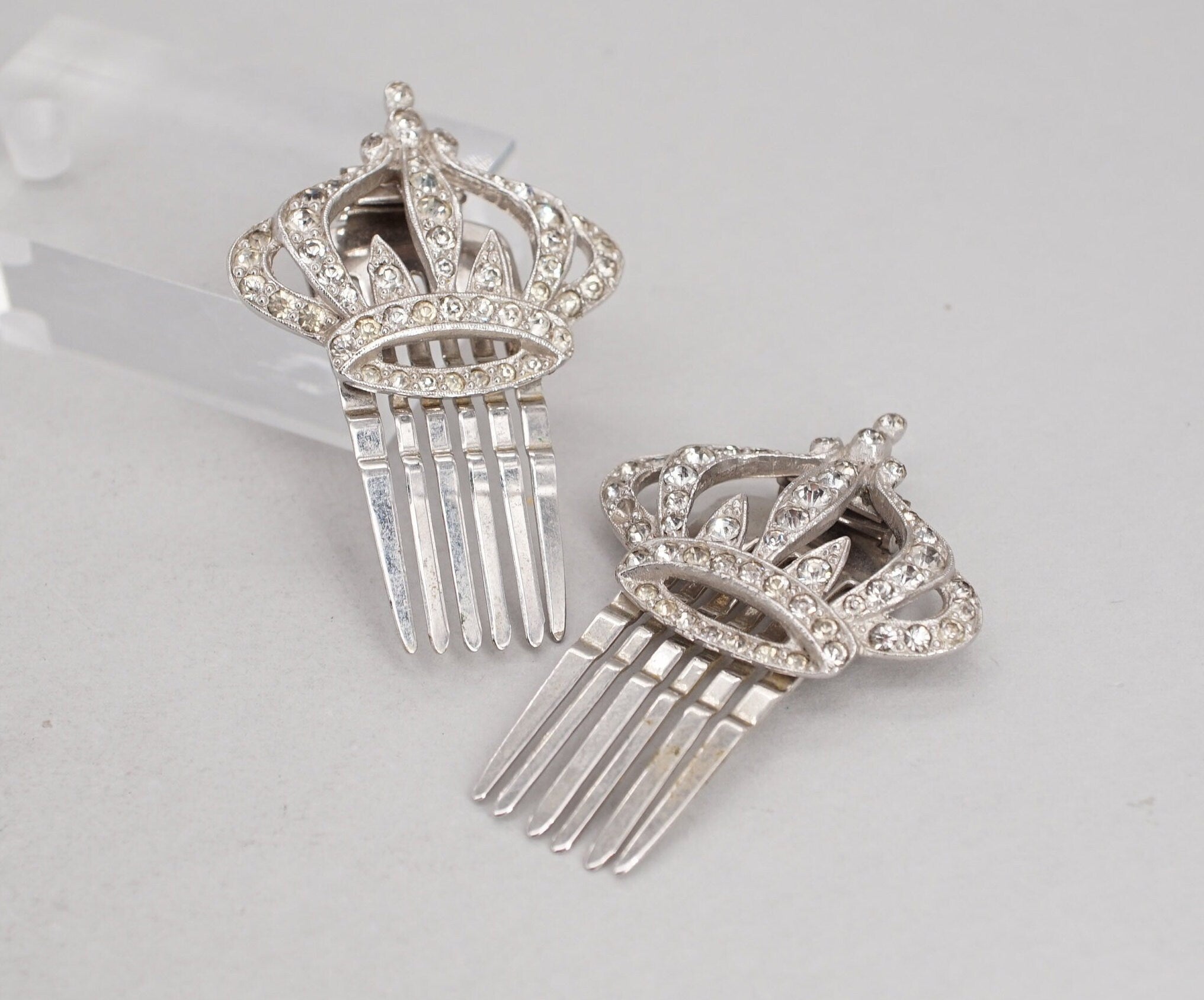 pair of coro silver tone rhinestone crown hair comb clips