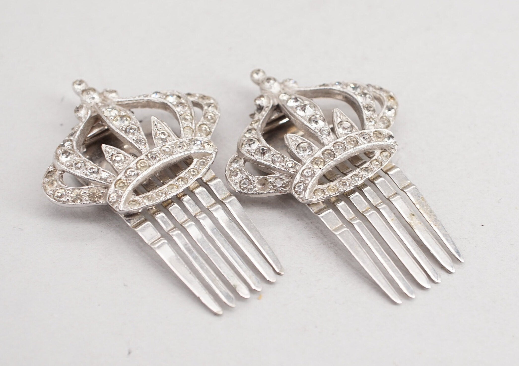pair of coro silver tone rhinestone crown hair comb clips