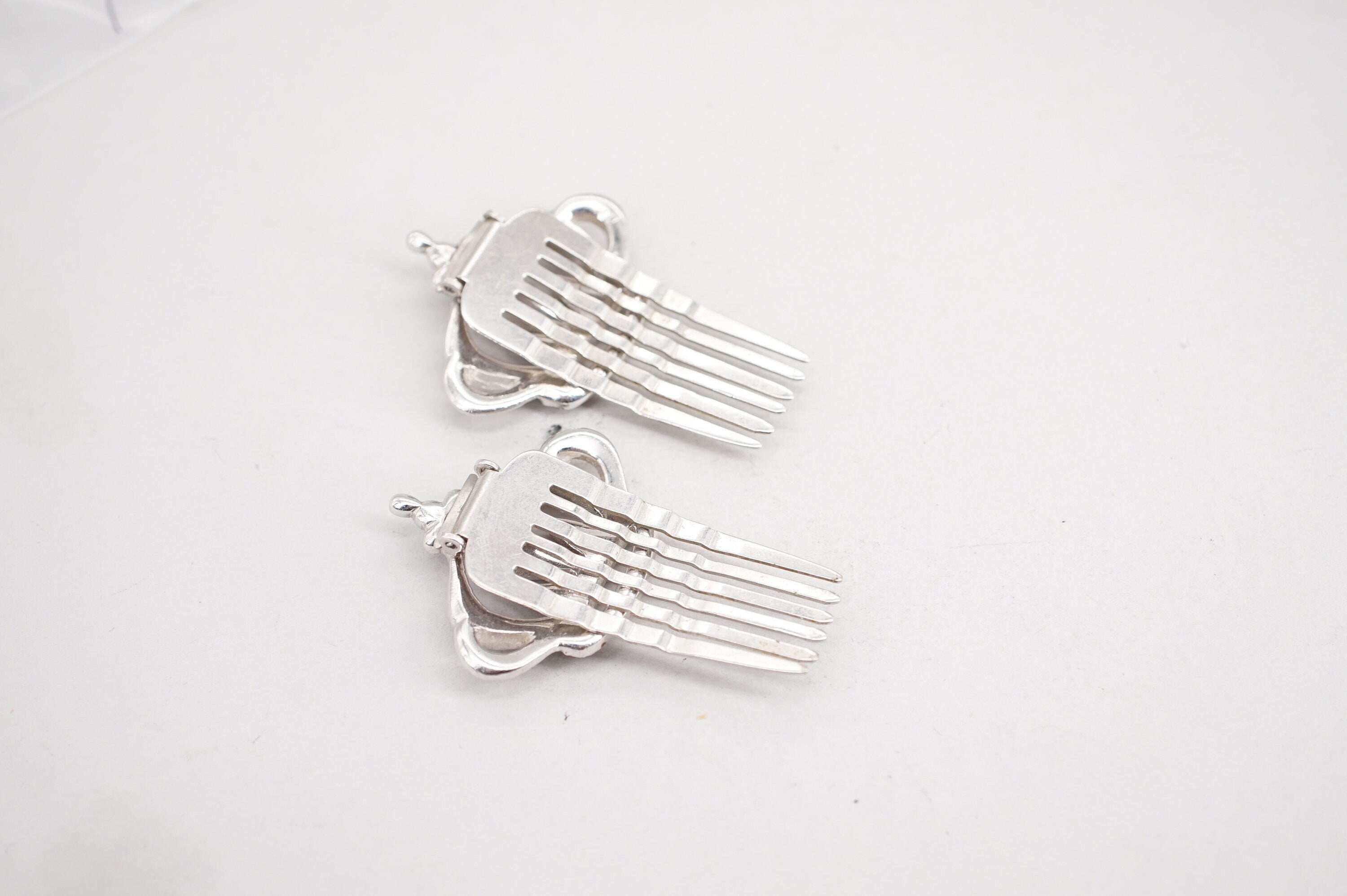 pair of coro silver tone rhinestone crown hair comb clips