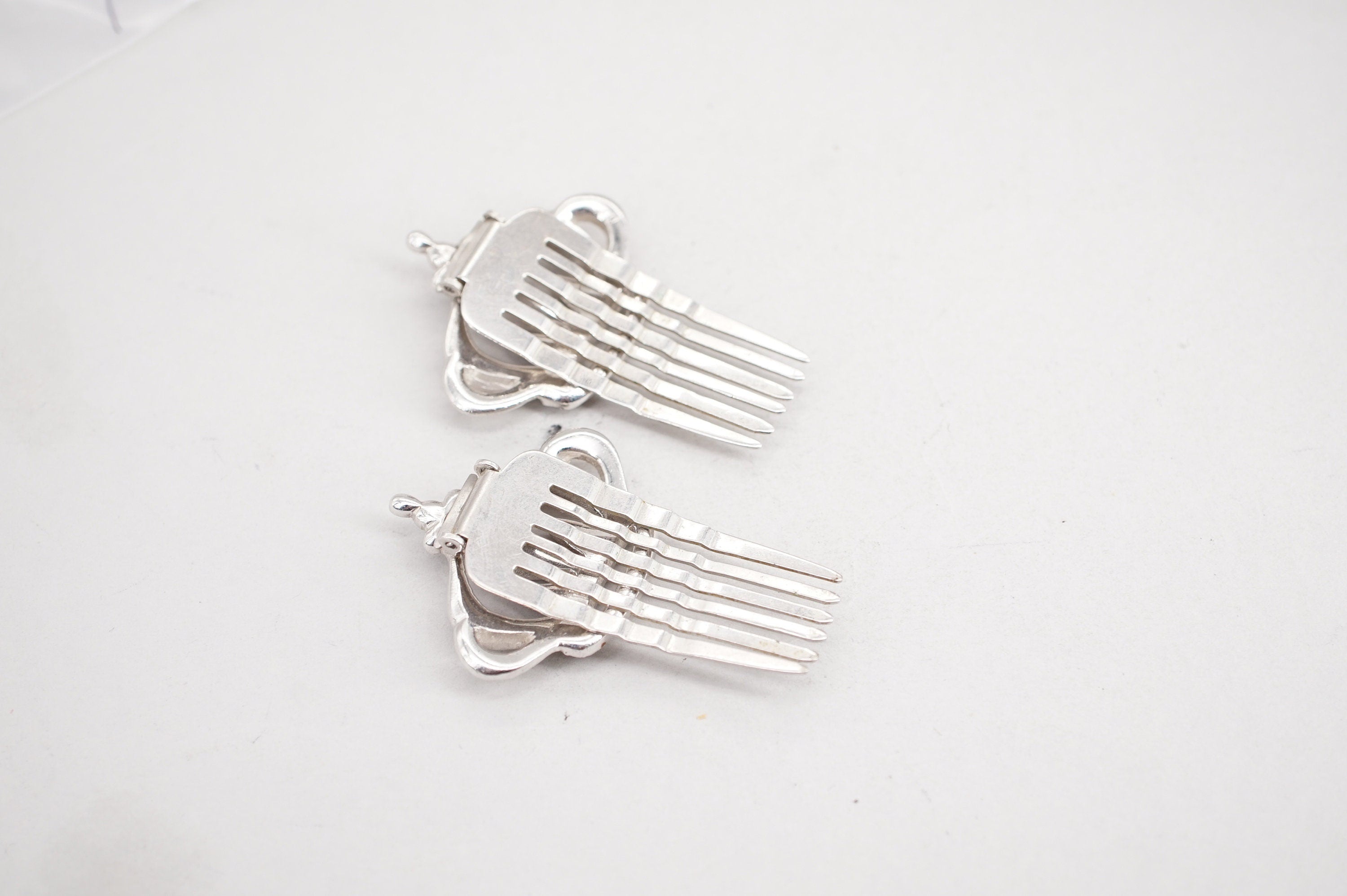 pair of coro silver tone rhinestone crown hair comb clips