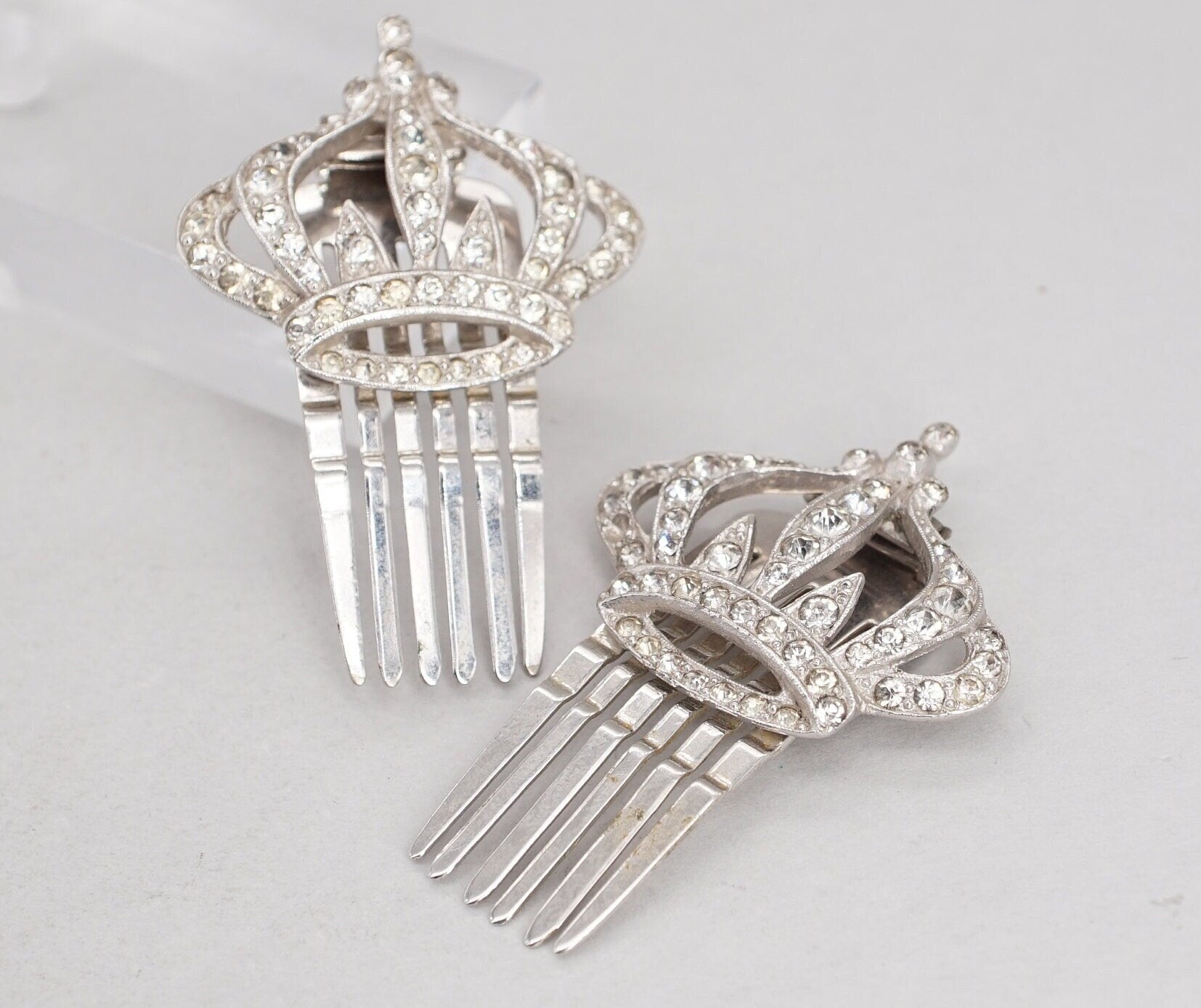 pair of coro silver tone rhinestone crown hair comb clips