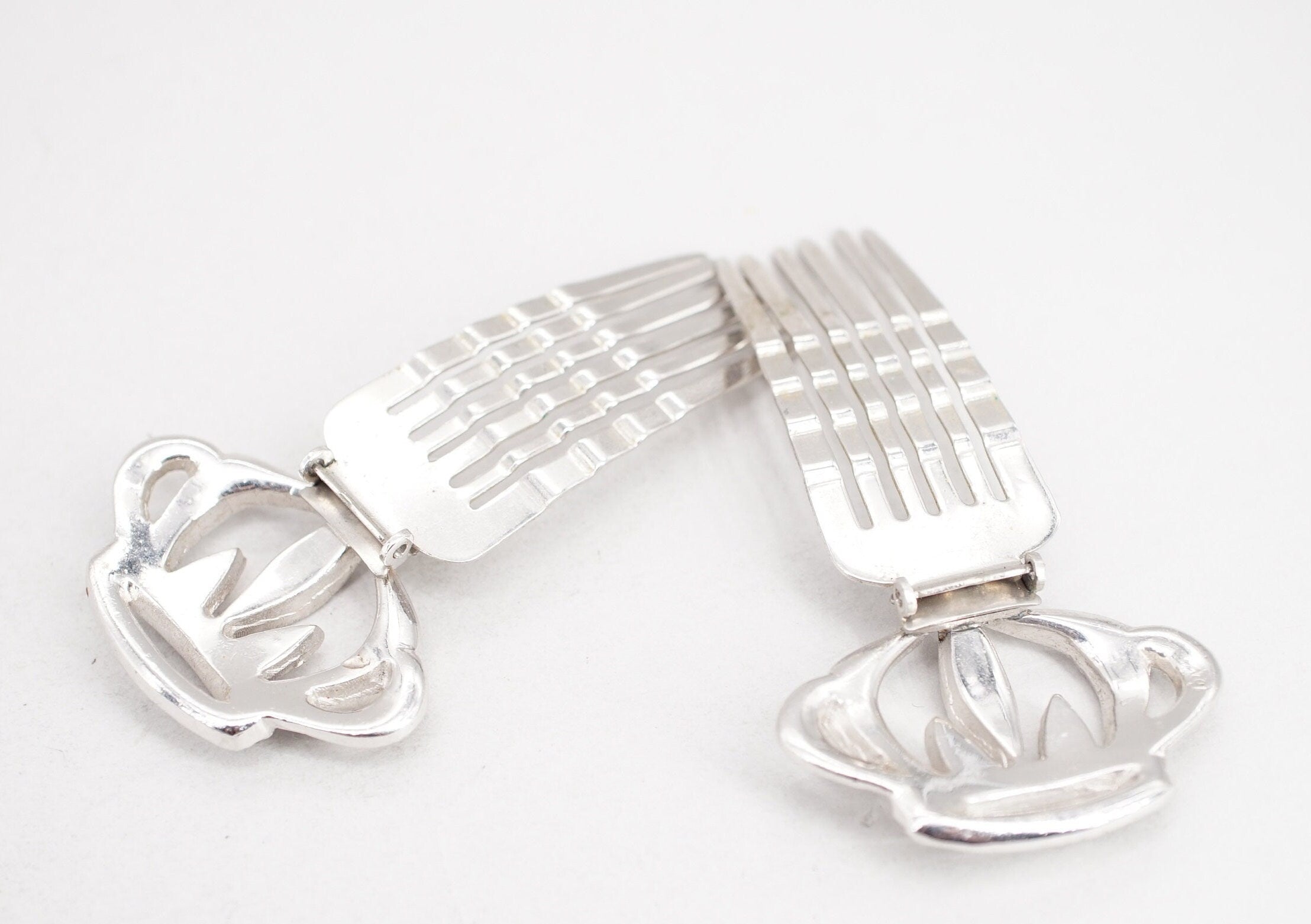 pair of coro silver tone rhinestone crown hair comb clips