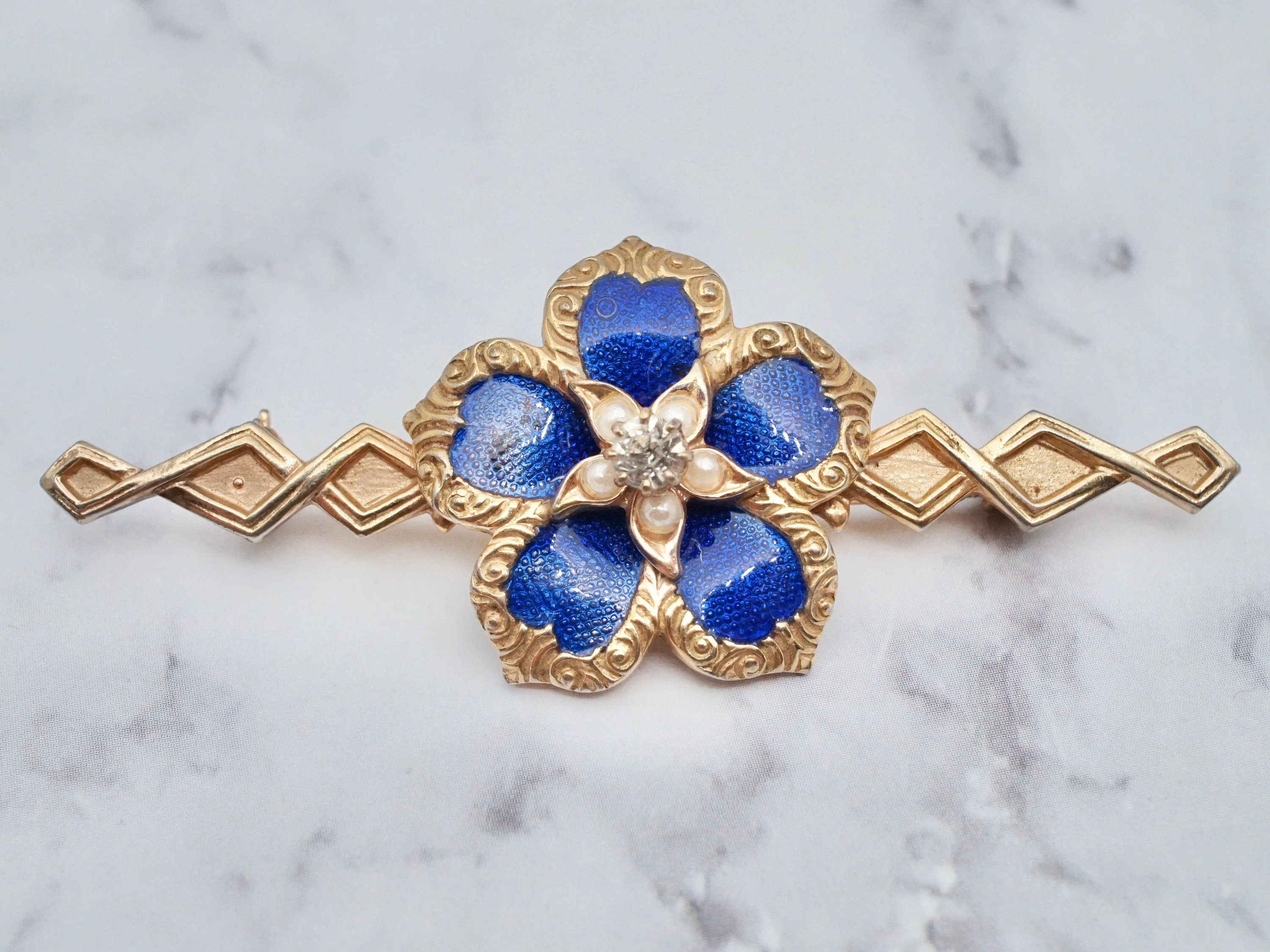 Vintage gold tone, enamel, rhinestone, and faux pearl flower brooch