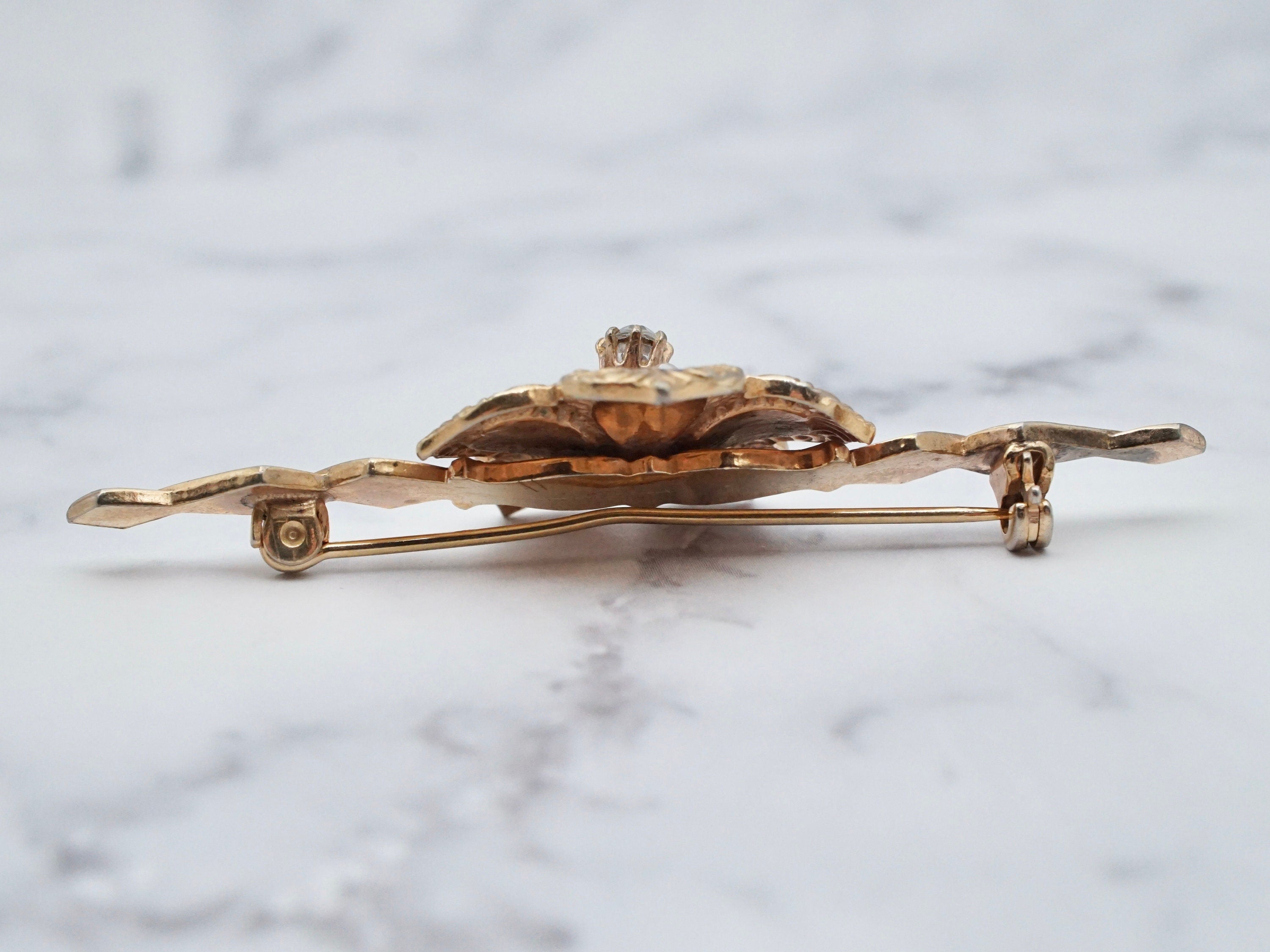Vintage gold tone, enamel, rhinestone, and faux pearl flower brooch