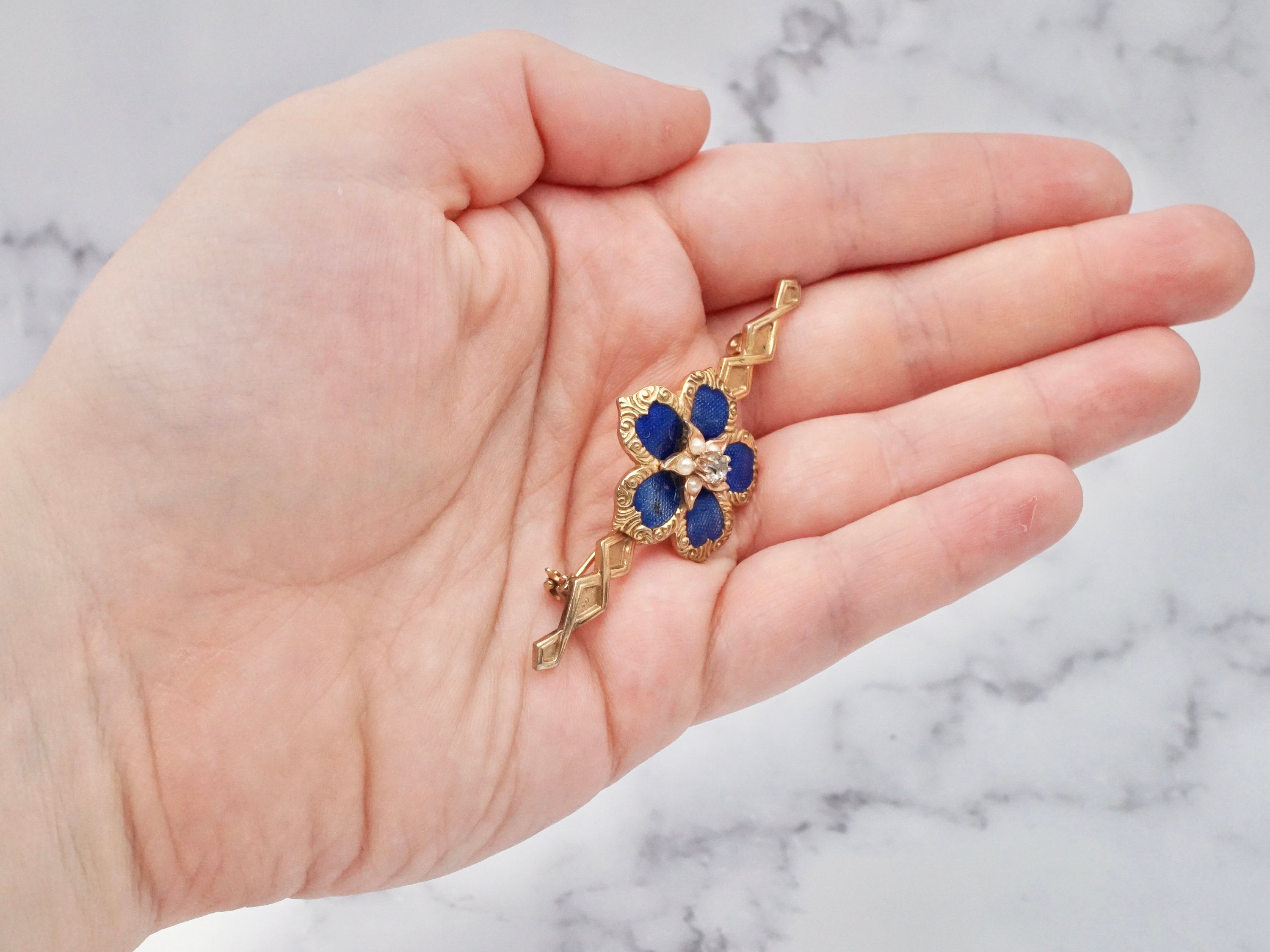 Vintage gold tone, enamel, rhinestone, and faux pearl flower brooch
