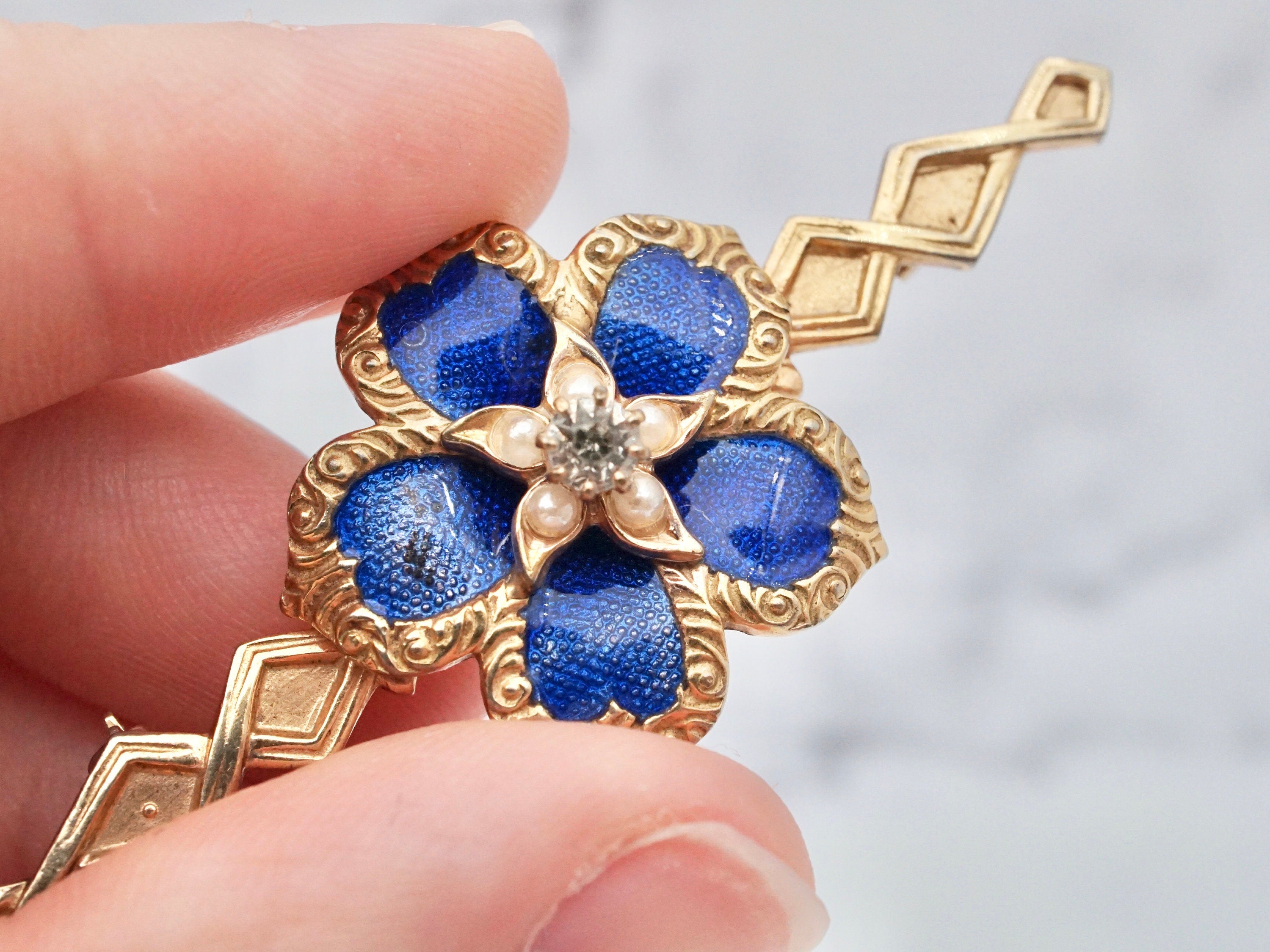 Vintage gold tone, enamel, rhinestone, and faux pearl flower brooch