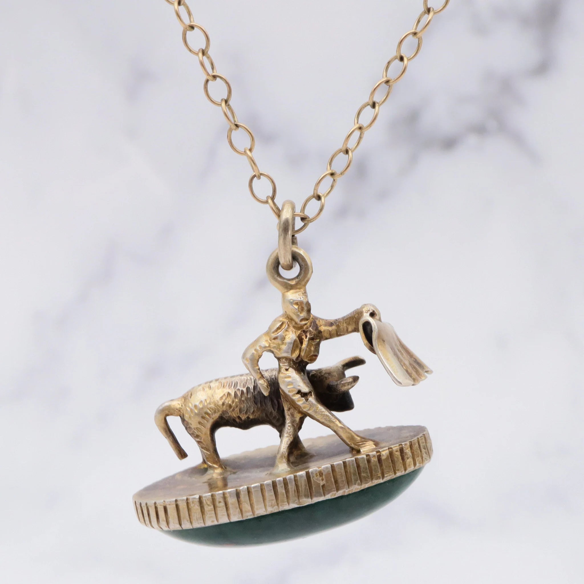 Antique gilt sterling figural matador & bull fob pendant with faux bloodstone