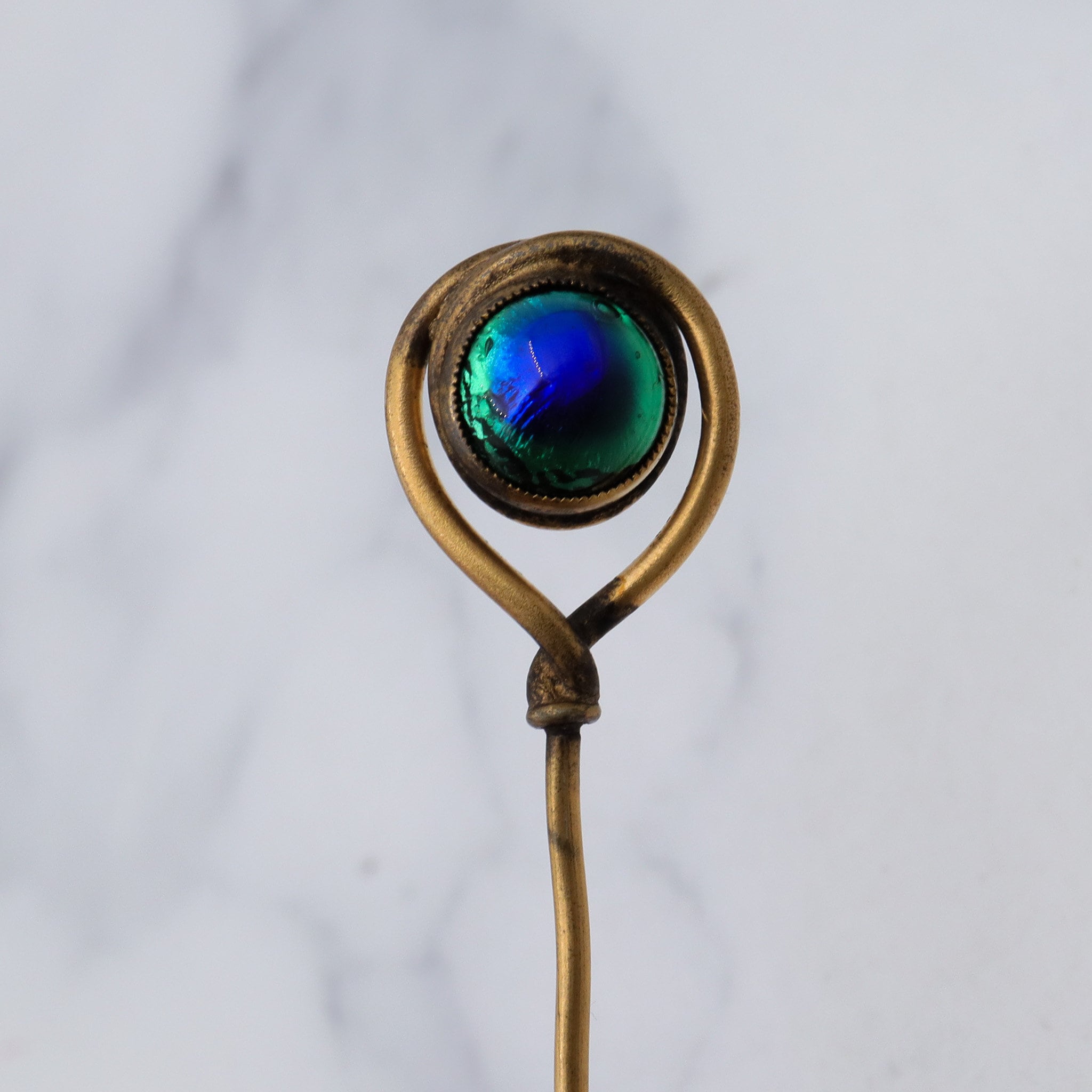 Antique Victorian gilt metal peacock eye glass swirl stick pin