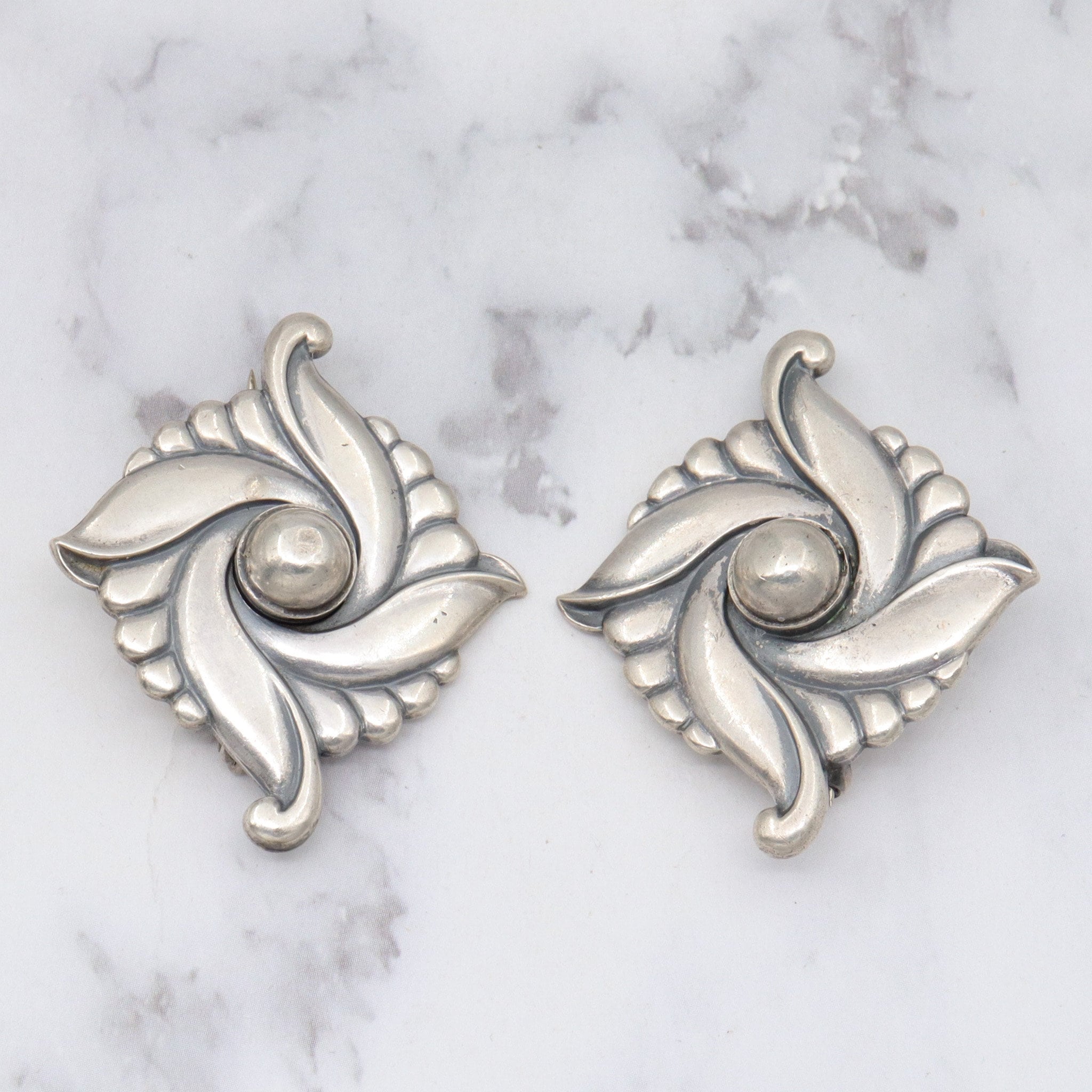 Pair of vintage Carl Ruopoli Mid-Century sterling swirl pins