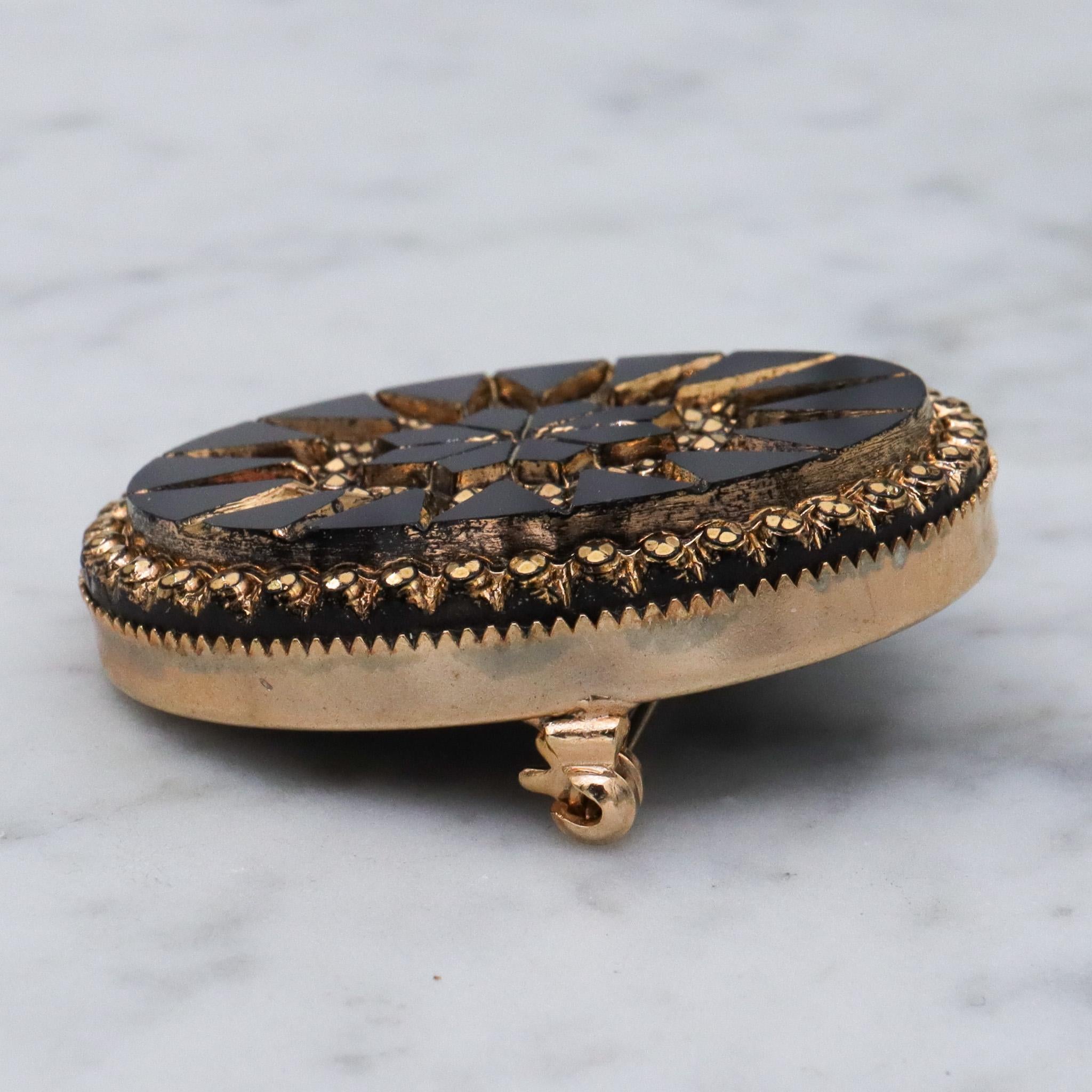 Victorian button style black glass brooch with gold sunburst