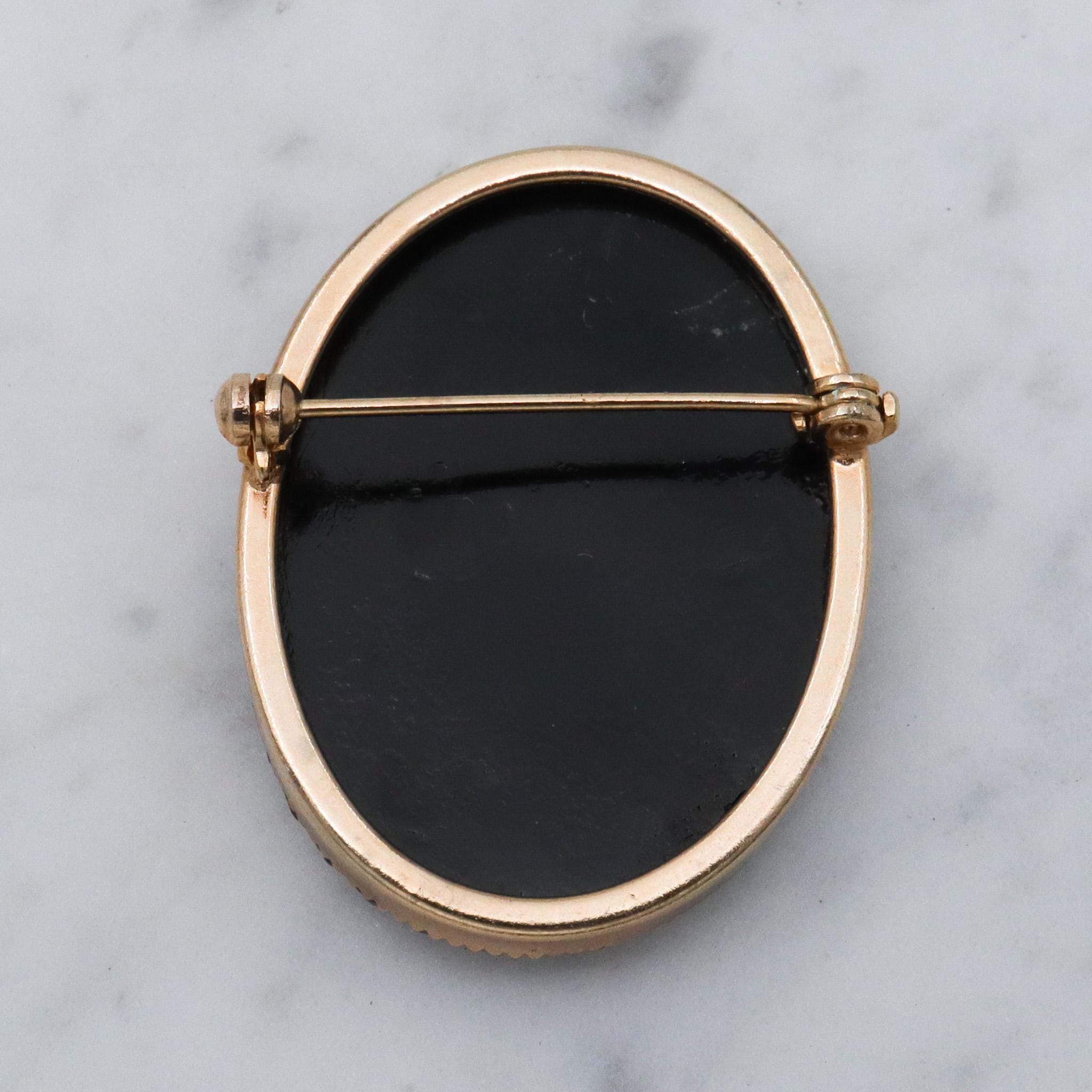 Victorian button style black glass brooch with gold sunburst