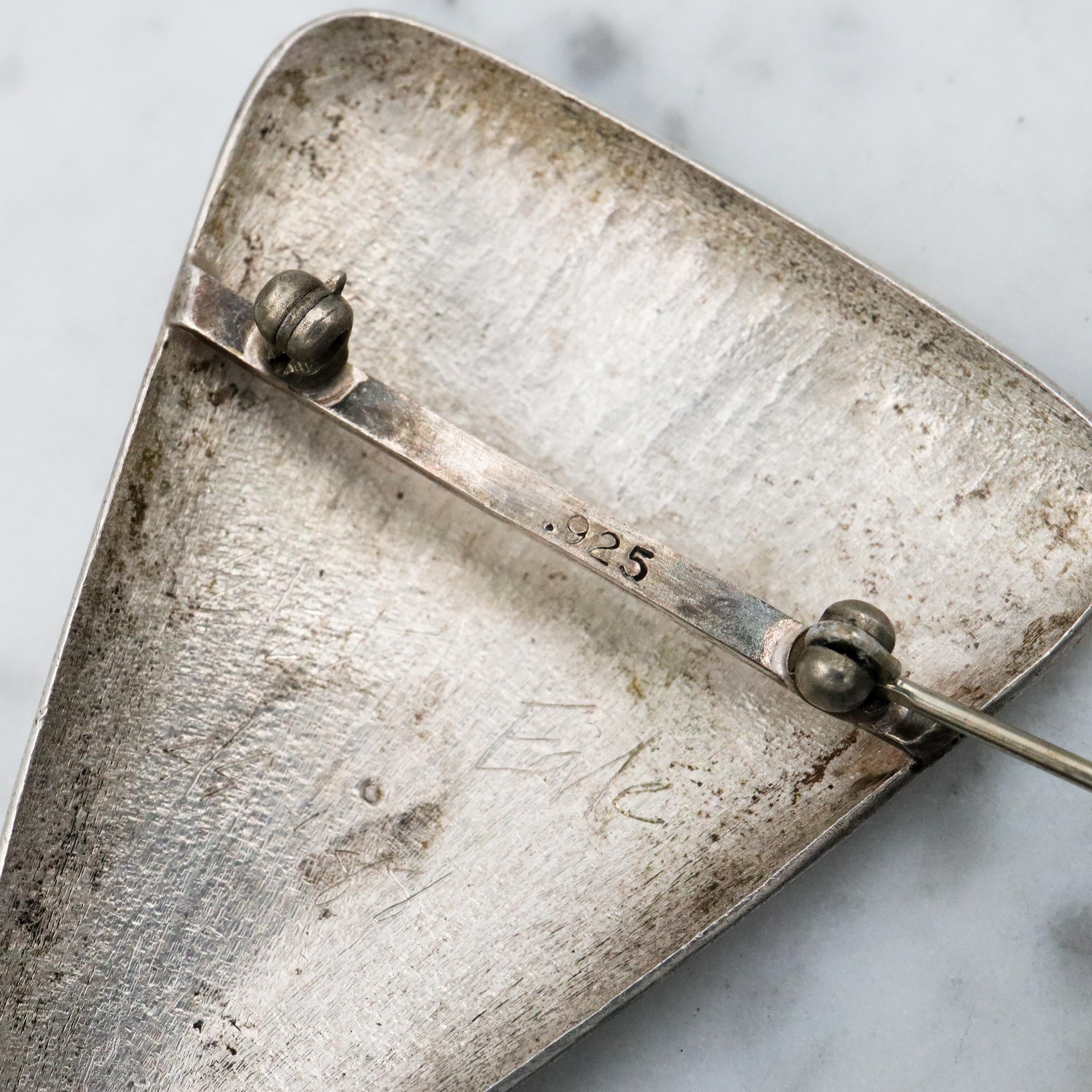 1987 pair of brushed sterling mask brooches by Modernist artist Elizabeth Earle